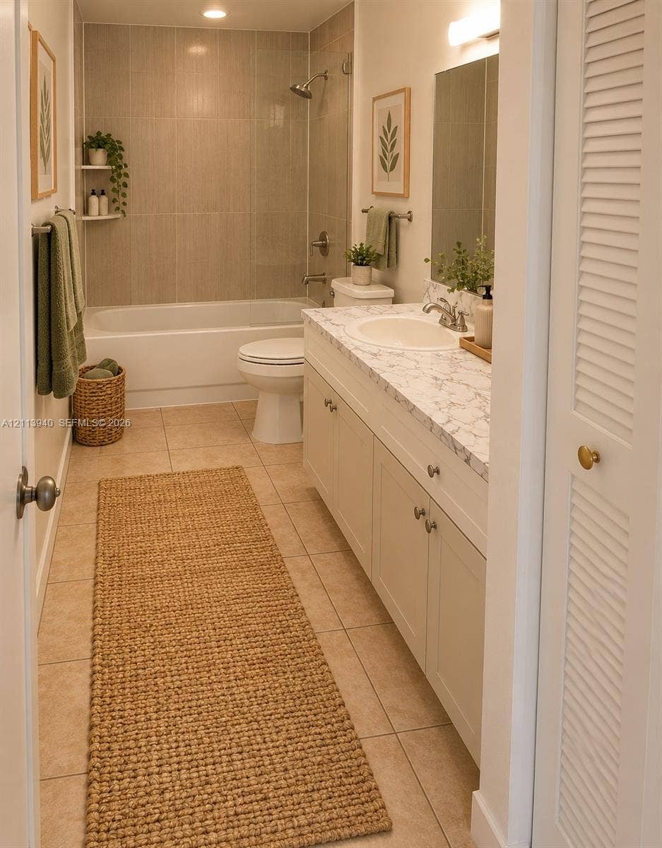 11150 SW 196th Street, #D211, Cutler Bay, Cutler Bay, FL 33157 Bathroom featuring a vanity with stone-patterned countertop, under-mount sink, tile flooring, built-in recessed shelving, and a shower-tub combination with floor-to-ceiling tile surround