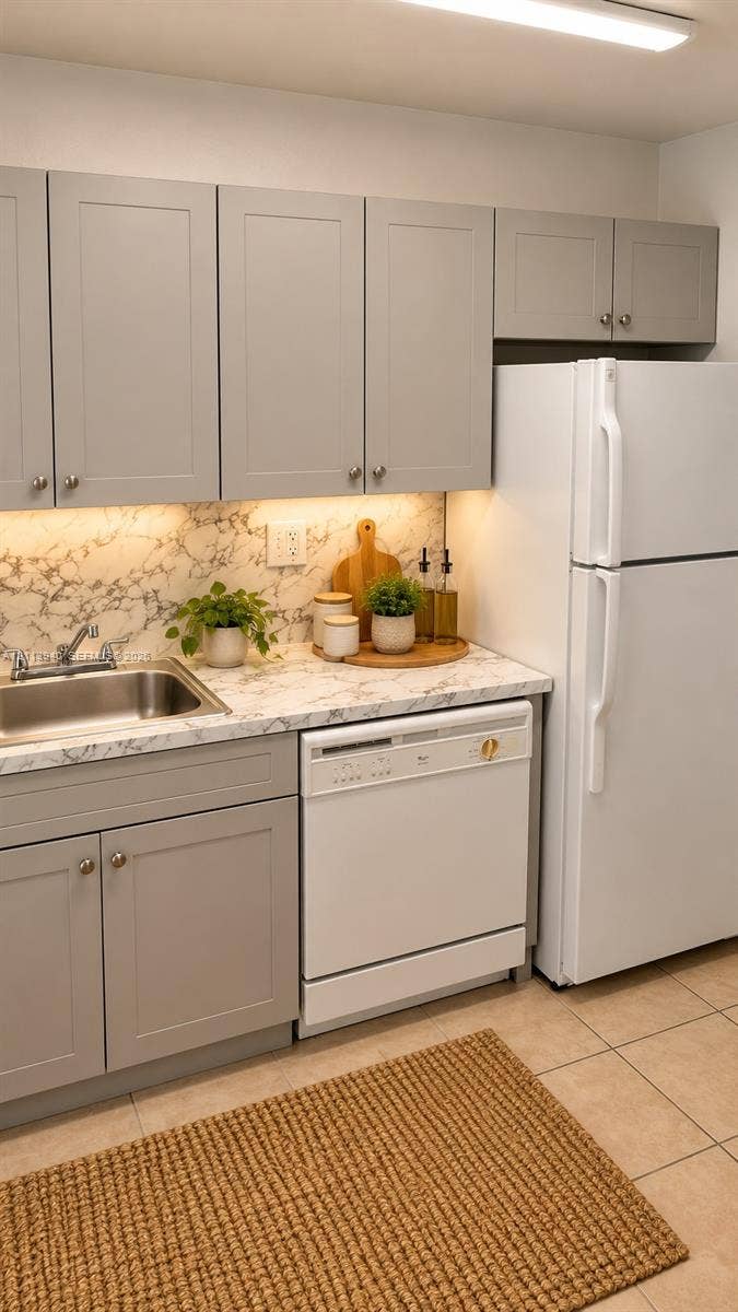 11150 SW 196th Street, #D211, Cutler Bay, Cutler Bay, FL 33157 Kitchen featuring gray shaker-style cabinetry, stone-patterned countertops, a stainless steel undermount sink, and tile flooring