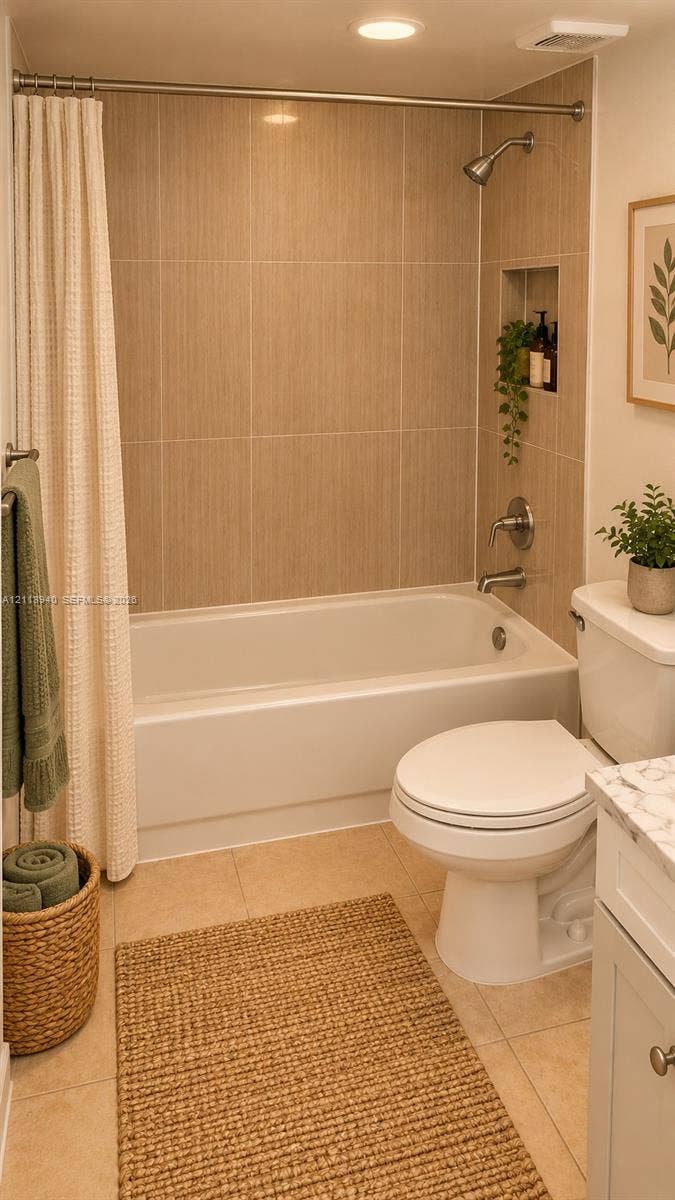 11150 SW 196th Street, #D211, Cutler Bay, Cutler Bay, FL 33157 Bathroom featuring a tub-shower combination with vertical tile surround, integrated wall niche, and polished metal fixtures, complemented by a white vanity with a stone-finish countertop