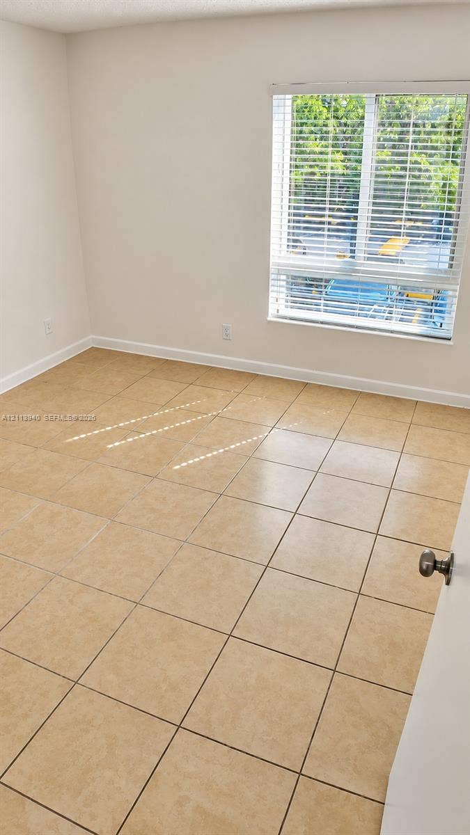 11150 SW 196th Street, #D211, Cutler Bay, Cutler Bay, FL 33157 Neutral-toned tile flooring throughout with a single-pane window featuring integrated horizontal blinds