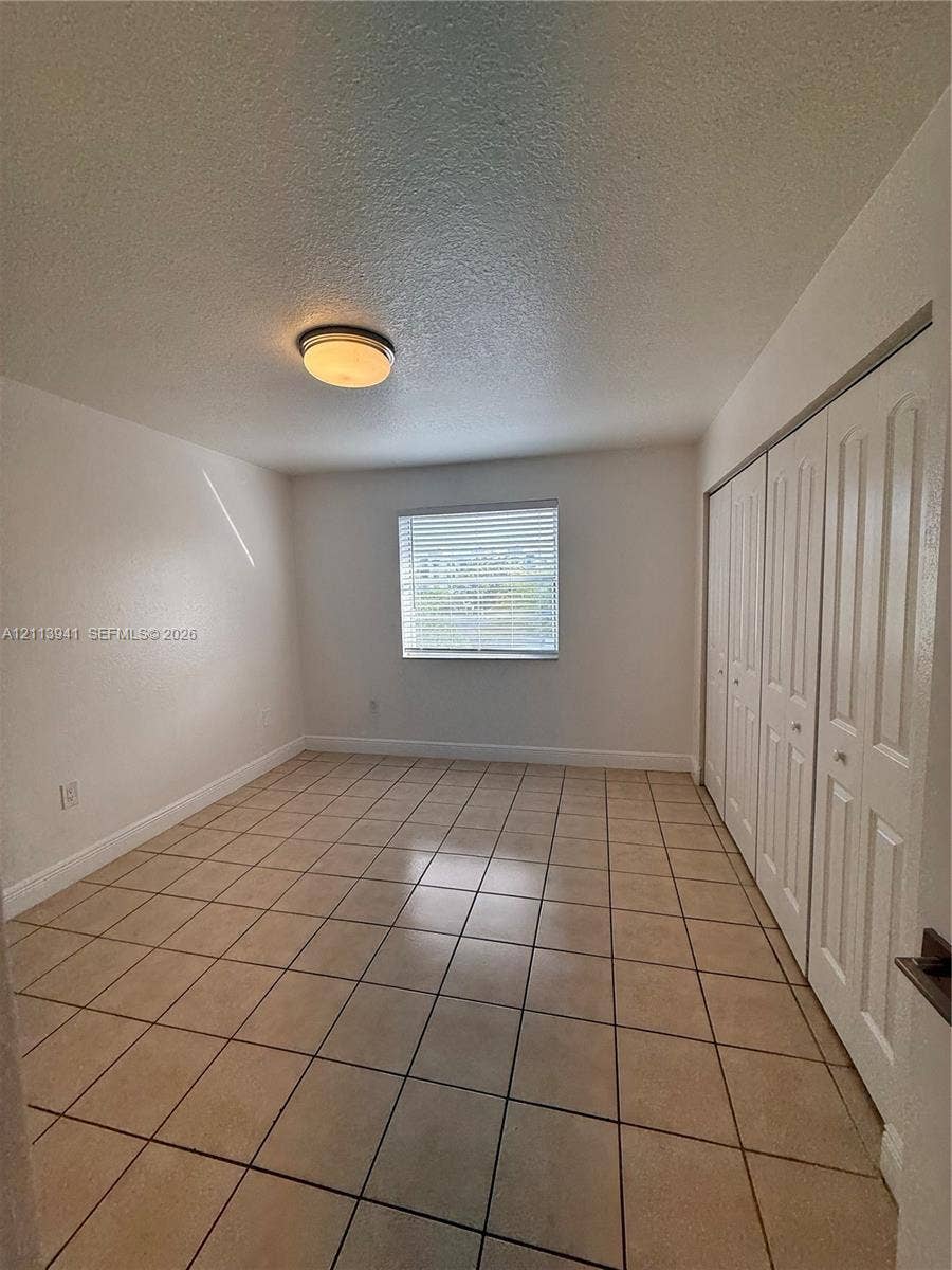 17255 SW 95th Avenue, #457, Palmetto Bay, Palmetto Bay, FL 33157 Tile flooring, multi-panel sliding closet doors, and flush-mount ceiling lighting
