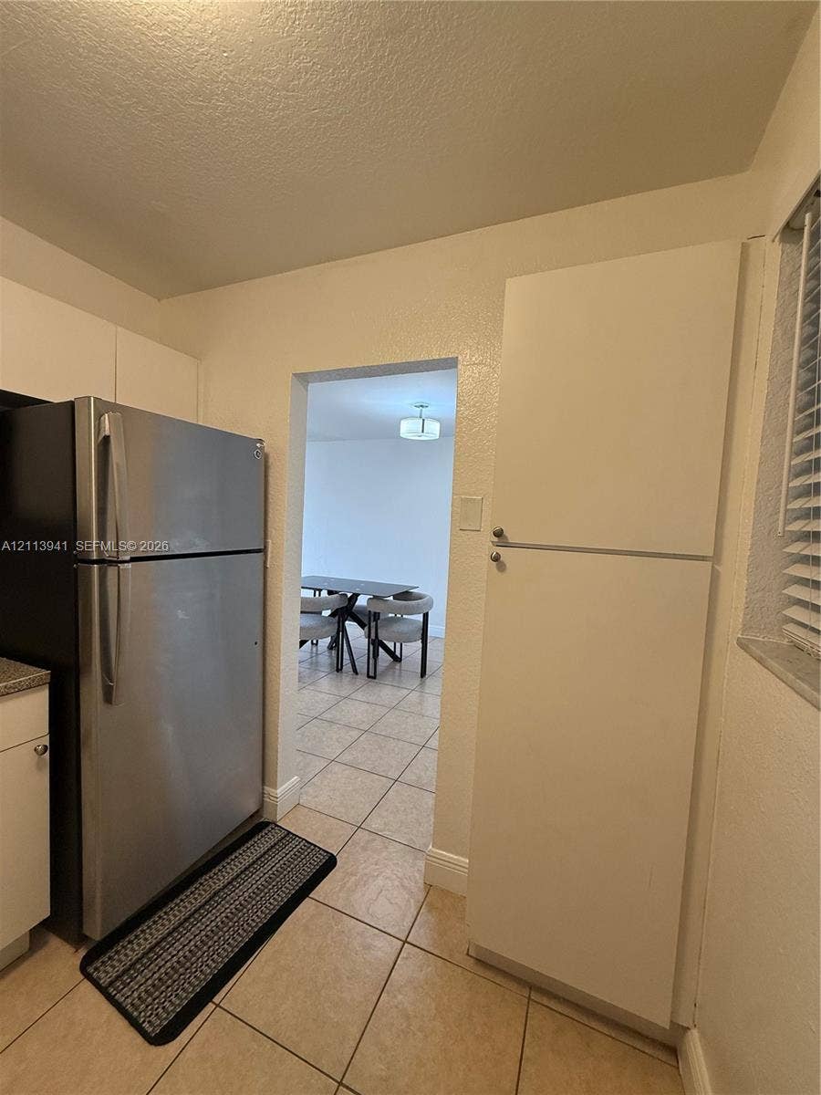 17255 SW 95th Avenue, #457, Palmetto Bay, Palmetto Bay, FL 33157 Kitchen featuring stainless steel refrigerator, tall pantry cabinetry, tile flooring, and window blinds