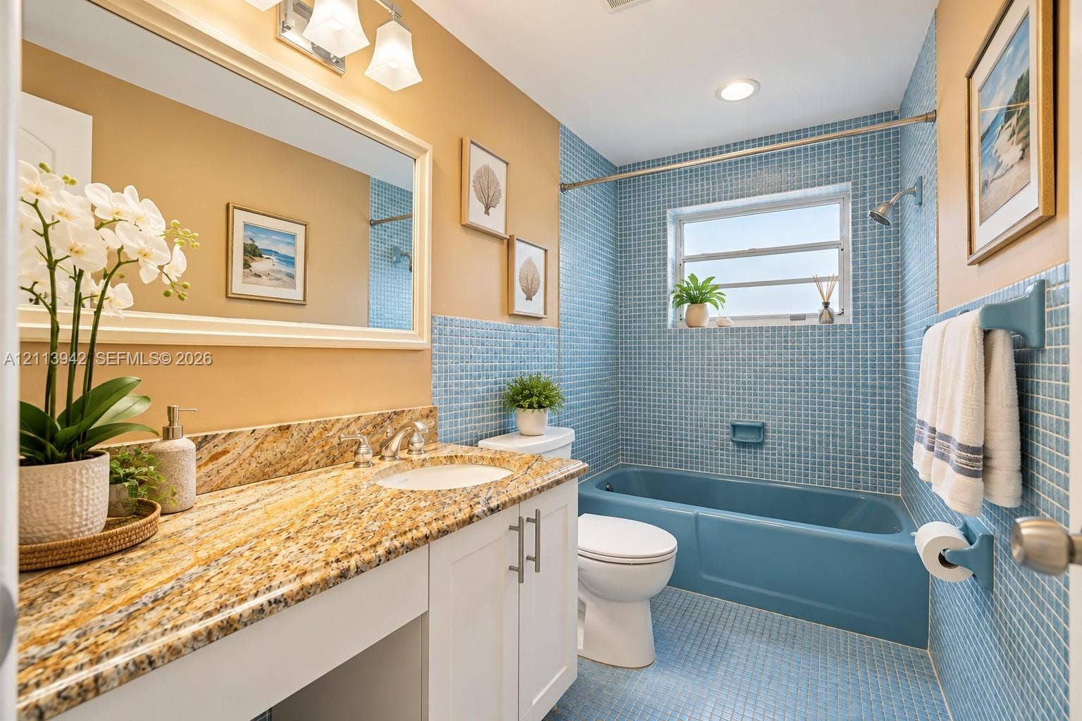 2710 S Ocean Drive, #401, Hollywood, FL 33019 Bathroom featuring a white vanity with stone-top surfacing, integrated porcelain sink, blue mosaic tile walls, and a matching blue porcelain bathtub