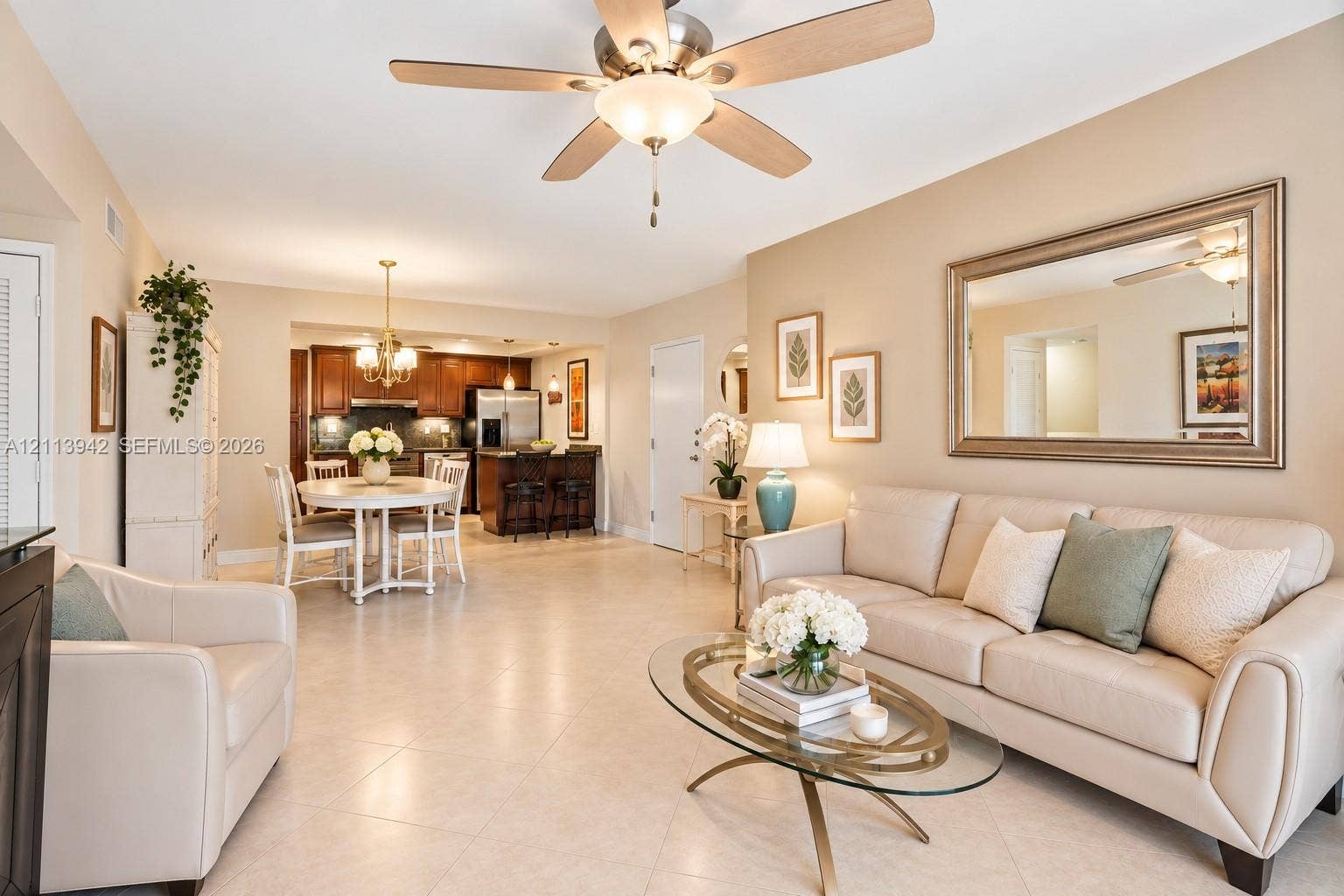 2710 S Ocean Drive, #401, Hollywood, FL 33019 Open-concept interior featuring large-format tile flooring, a central ceiling fan with integrated lighting, recessed cabinetry, and a breakfast bar