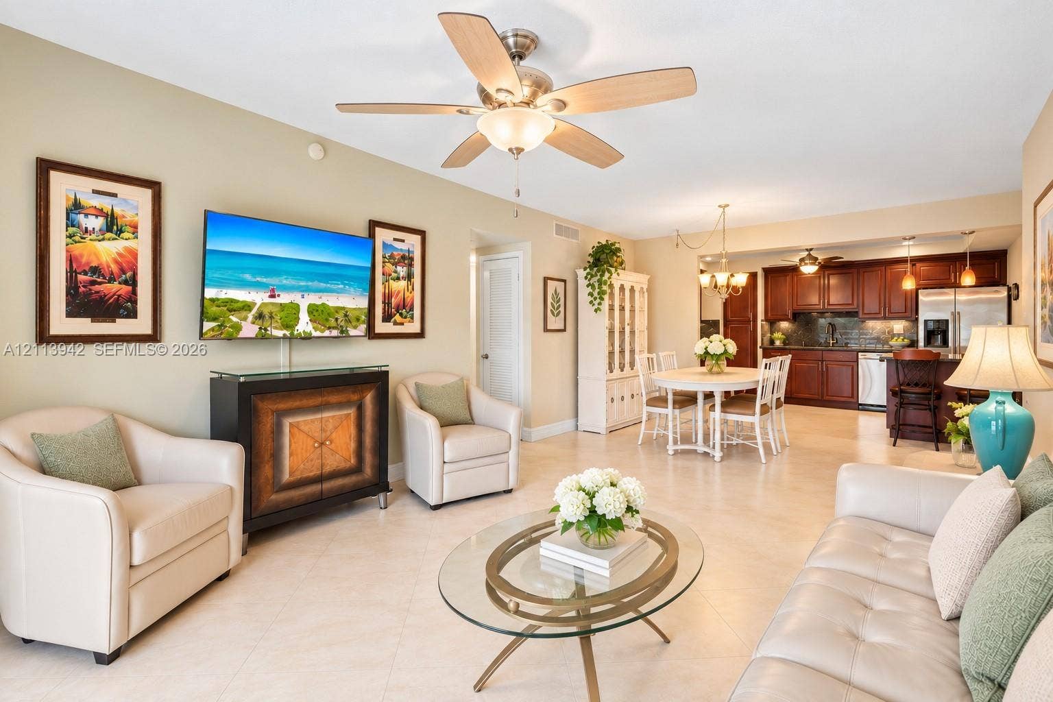 2710 S Ocean Drive, #401, Hollywood, FL 33019 Open-concept living space featuring large-format tile flooring, recessed ceiling lighting, a multi-blade ceiling fan, and a kitchen equipped with dark wood cabinetry