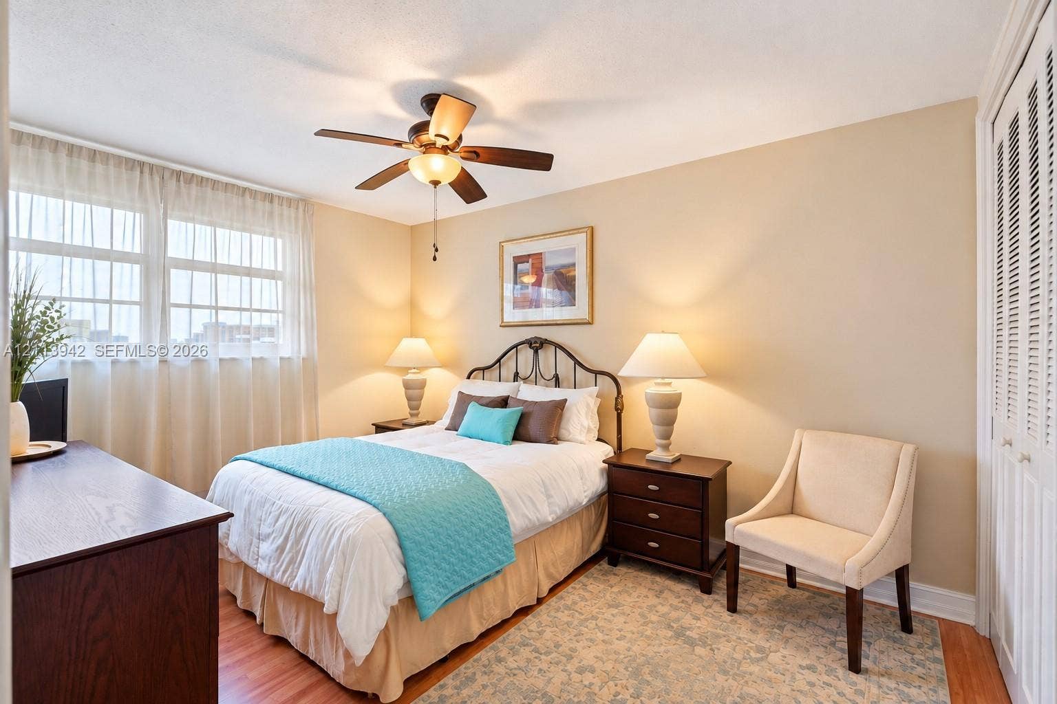 2710 S Ocean Drive, #401, Hollywood, FL 33019 Multi-pane window, wood-finish flooring, ceiling fan with integrated lighting, and louvered double-door closet