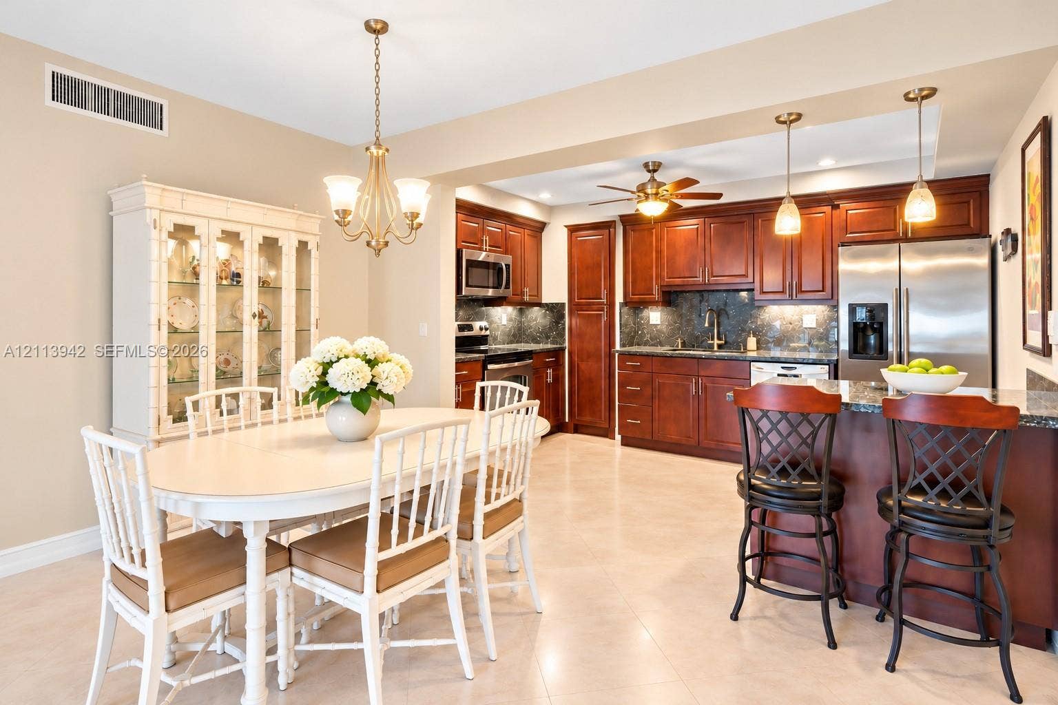 2710 S Ocean Drive, #401, Hollywood, FL 33019 Kitchen featuring rich wood cabinetry, stone-surface countertops, stainless steel appliances, and a central island with pendant lighting