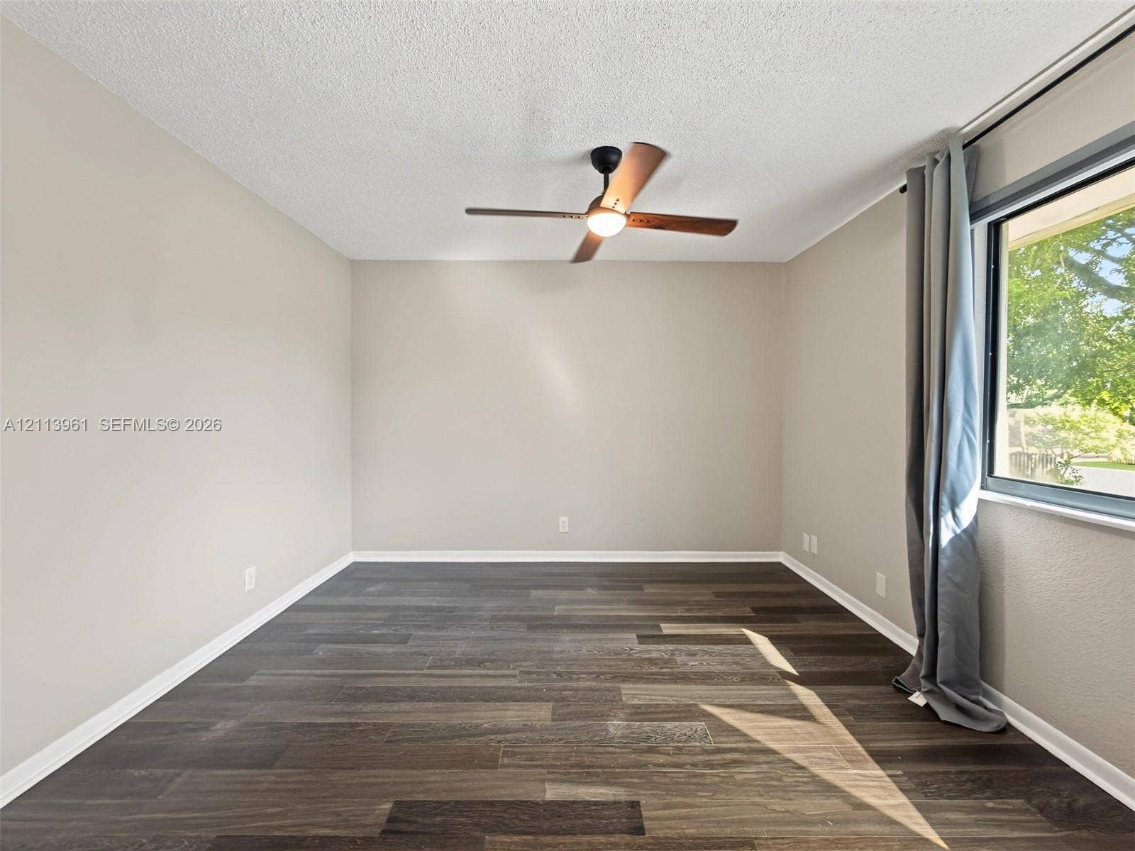 339 City View Drive, #339, Fort Lauderdale, Fort Lauderdale, FL 33311 Neutral-toned walls, wood-finish flooring, and a ceiling-mounted fan with integrated lighting