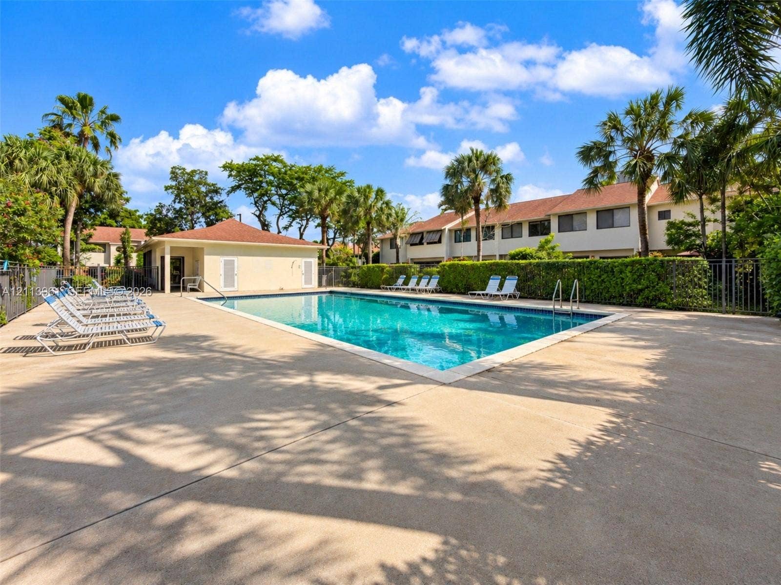 339 City View Drive, #339, Fort Lauderdale, Fort Lauderdale, FL 33311 Swimming pool with a concrete deck, pool house, and surrounding mature landscaping