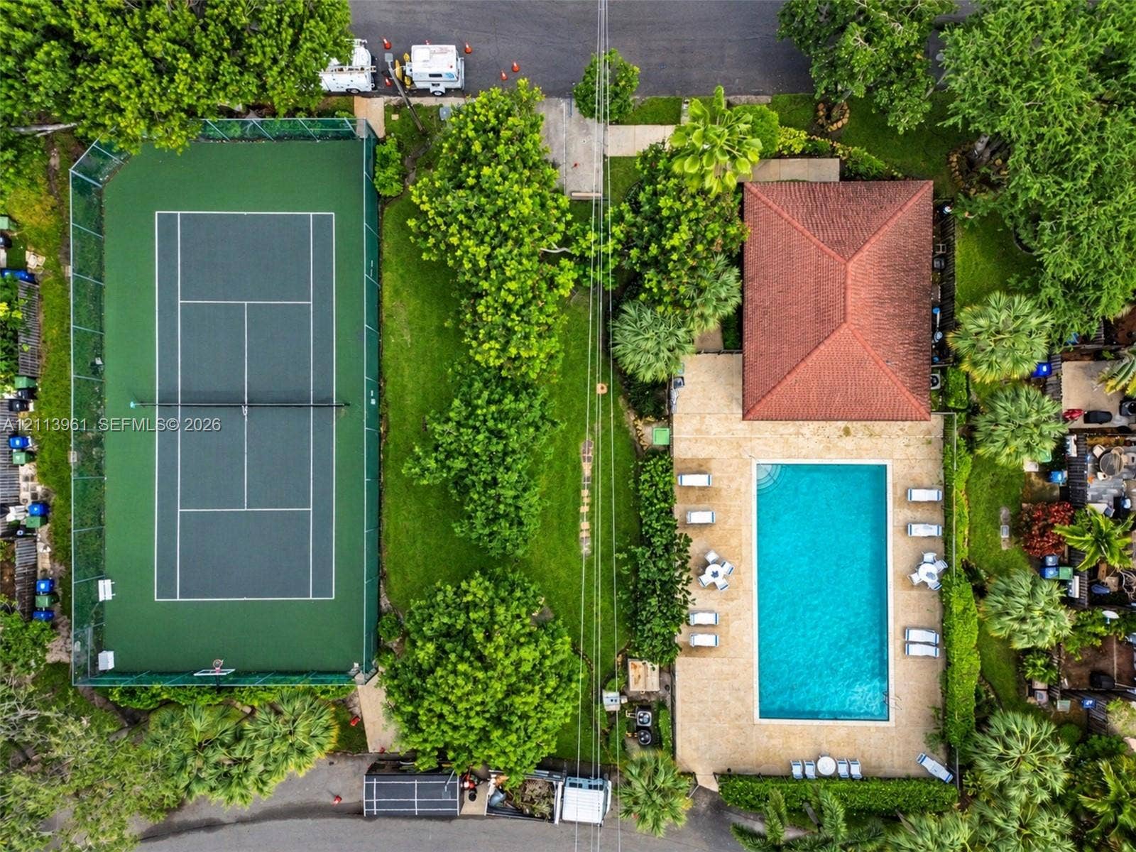 339 City View Drive, #339, Fort Lauderdale, Fort Lauderdale, FL 33311 Fenced tennis court, rectangular swimming pool with stone-finish decking, and mature landscaping