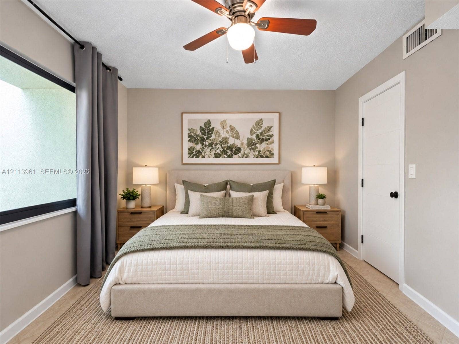 339 City View Drive, #339, Fort Lauderdale, Fort Lauderdale, FL 33311 Neutral-toned room featuring a central ceiling fan with an integrated light fixture, horizontal paneled door with matte black hardware, and large-format window