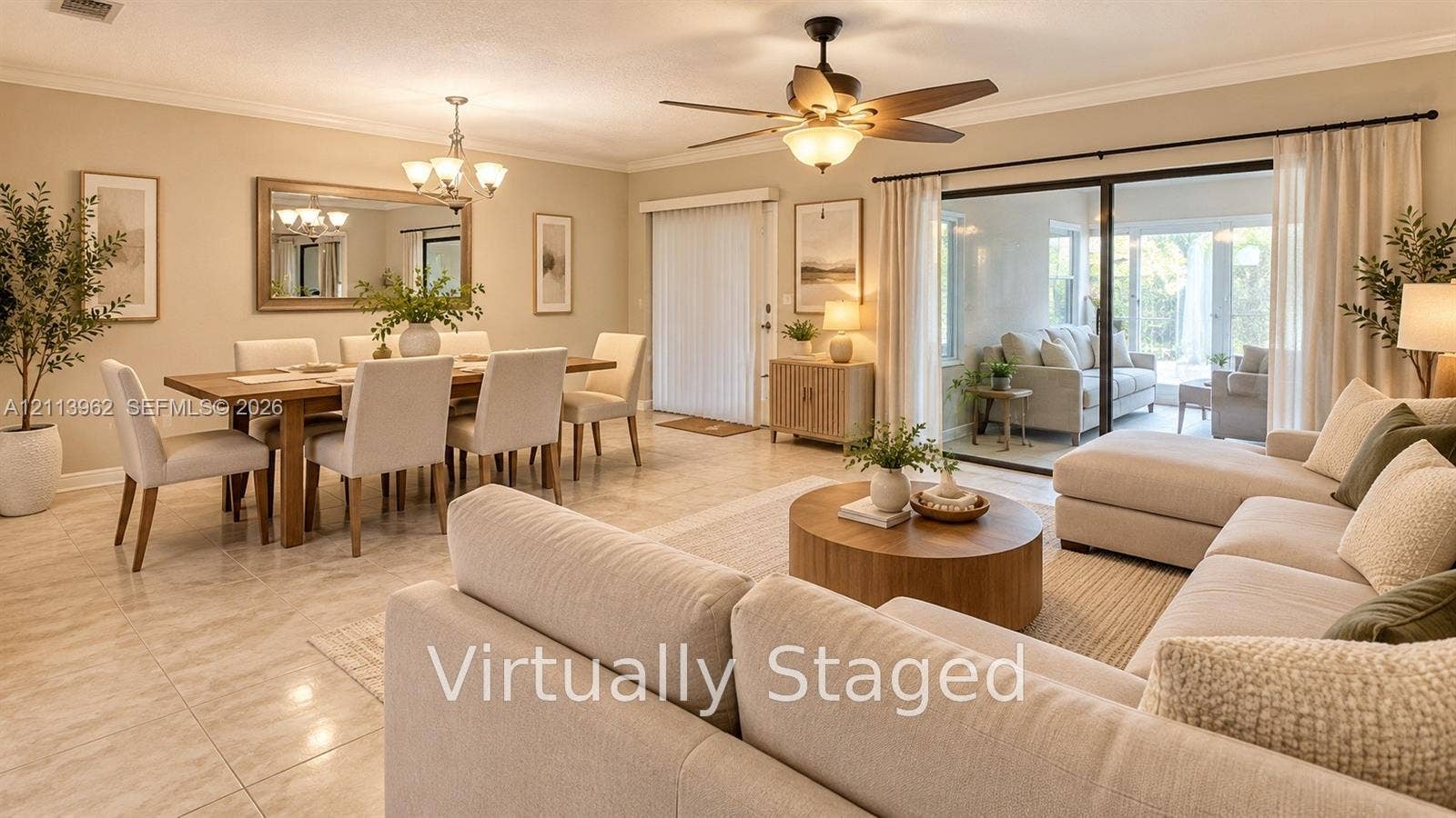 19764 NW 54 Avenue, Miami Gardens, FL 33055 Open-concept interior featuring large-format tile flooring, a multi-blade ceiling fan with integrated lighting, crown molding, and sliding glass doors