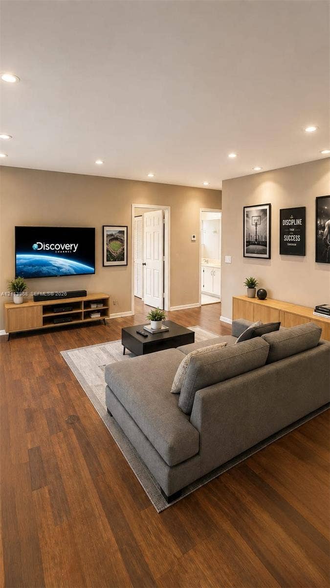 Living area featuring wood-finish flooring, recessed lighting, and neutral wall tones