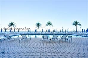 1904 S Ocean Drive, #1001, Hallandale Beach, Hallandale Beach, FL 33009 Swimming pool with a tile-patterned deck and perimeter palm trees