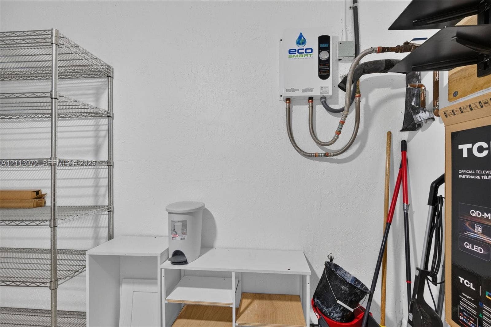 Wall-mounted tankless electric water heater featuring a digital temperature display