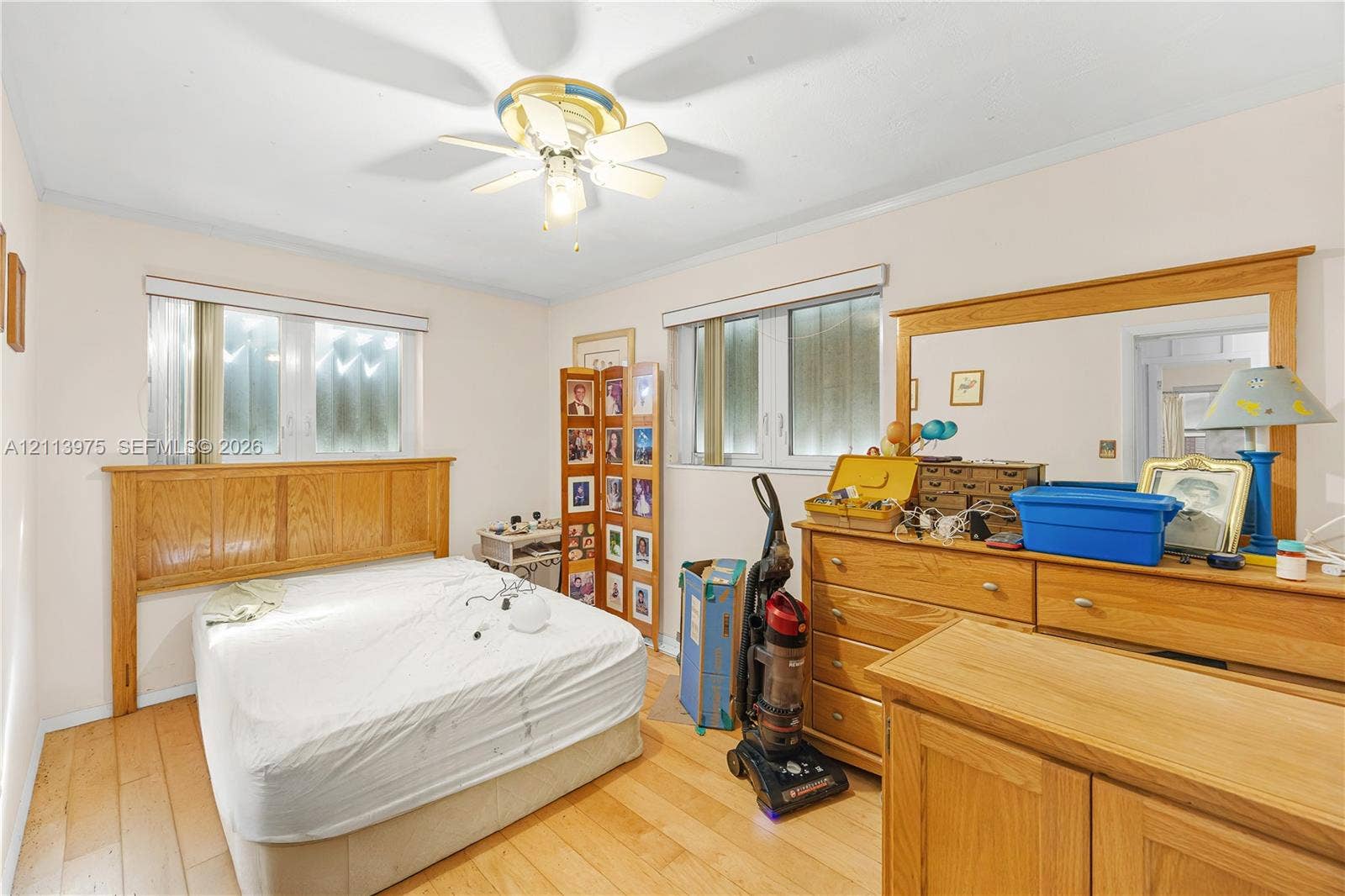 3740 NE 6th Avenue, Oakland Park, FL 33334 Wood-finish flooring, dual windows with blinds, and a central ceiling fan with integrated light fixture