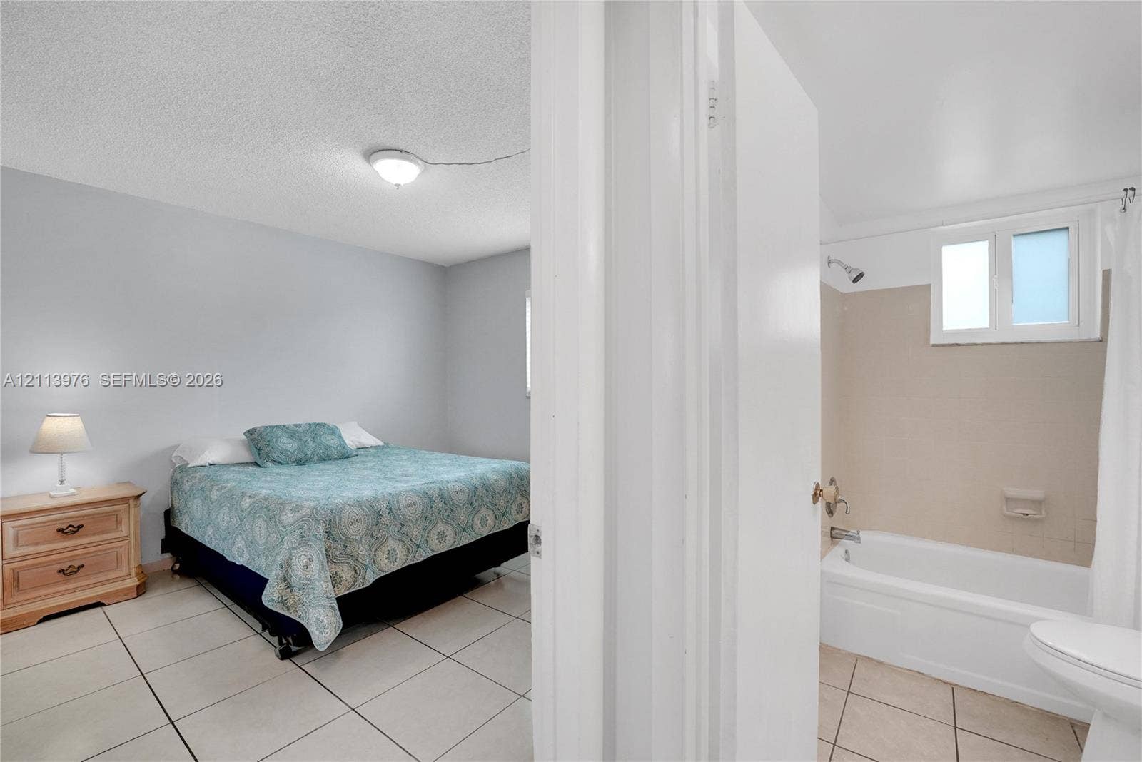 2145 Pierce Street, #416, Hollywood, FL 33020 Room featuring large-format ceramic tile flooring and a standard bathtub with a wall-mounted shower fixture and tile surround