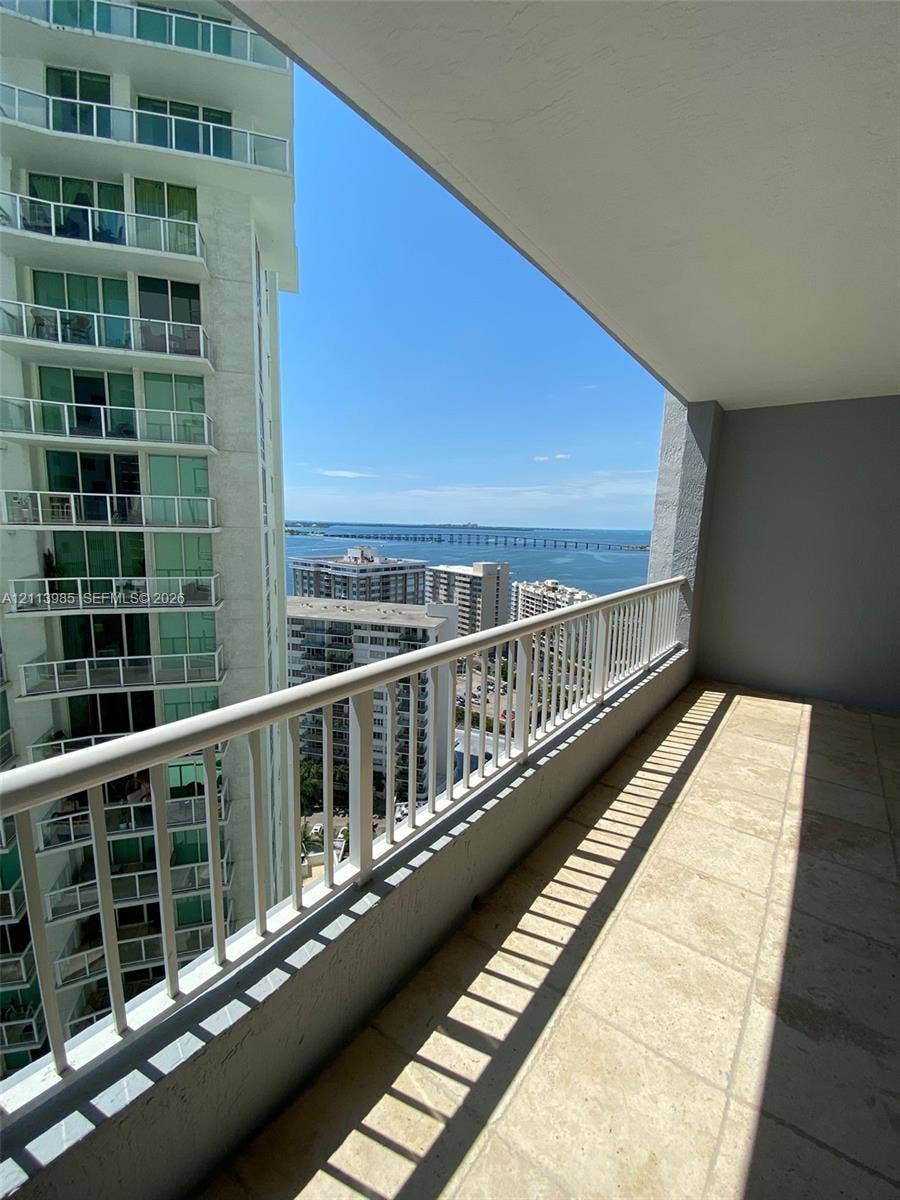 170 SE 14th Street, #2203, Miami, Miami, FL 33131 Covered balcony featuring natural stone tile flooring and white metal railings