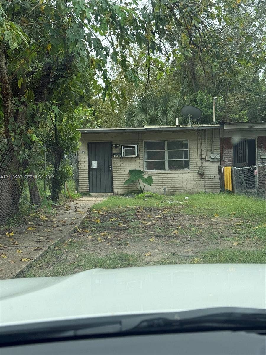4428 Friden Drive, #4428, Jacksonville, Jacksonville, FL 32209 Exterior featuring a light-colored brick facade, a single-story profile, a metal security door, and a concrete walkway