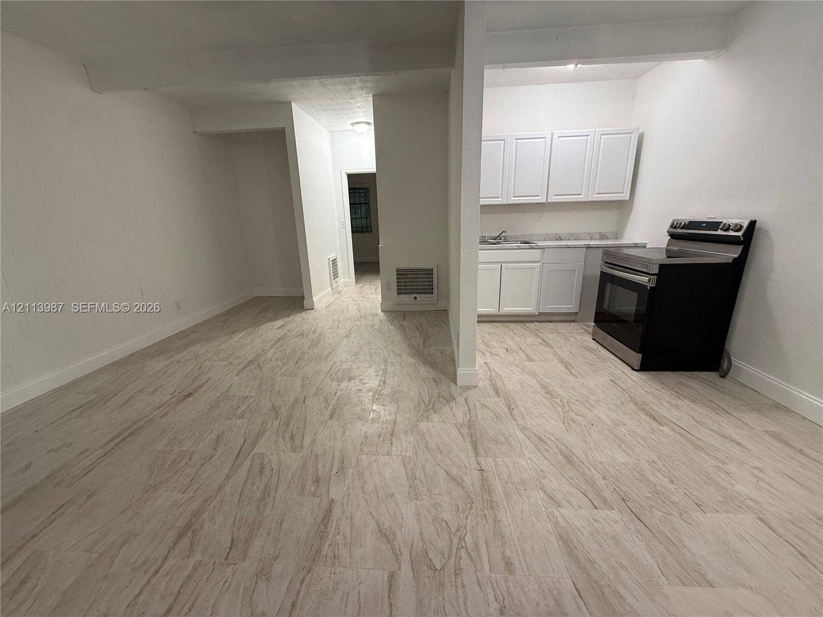 4428 Friden Drive, #4428, Jacksonville, Jacksonville, FL 32209 Wood-finish flooring throughout, white cabinetry with stone-finish countertops, and stainless steel range