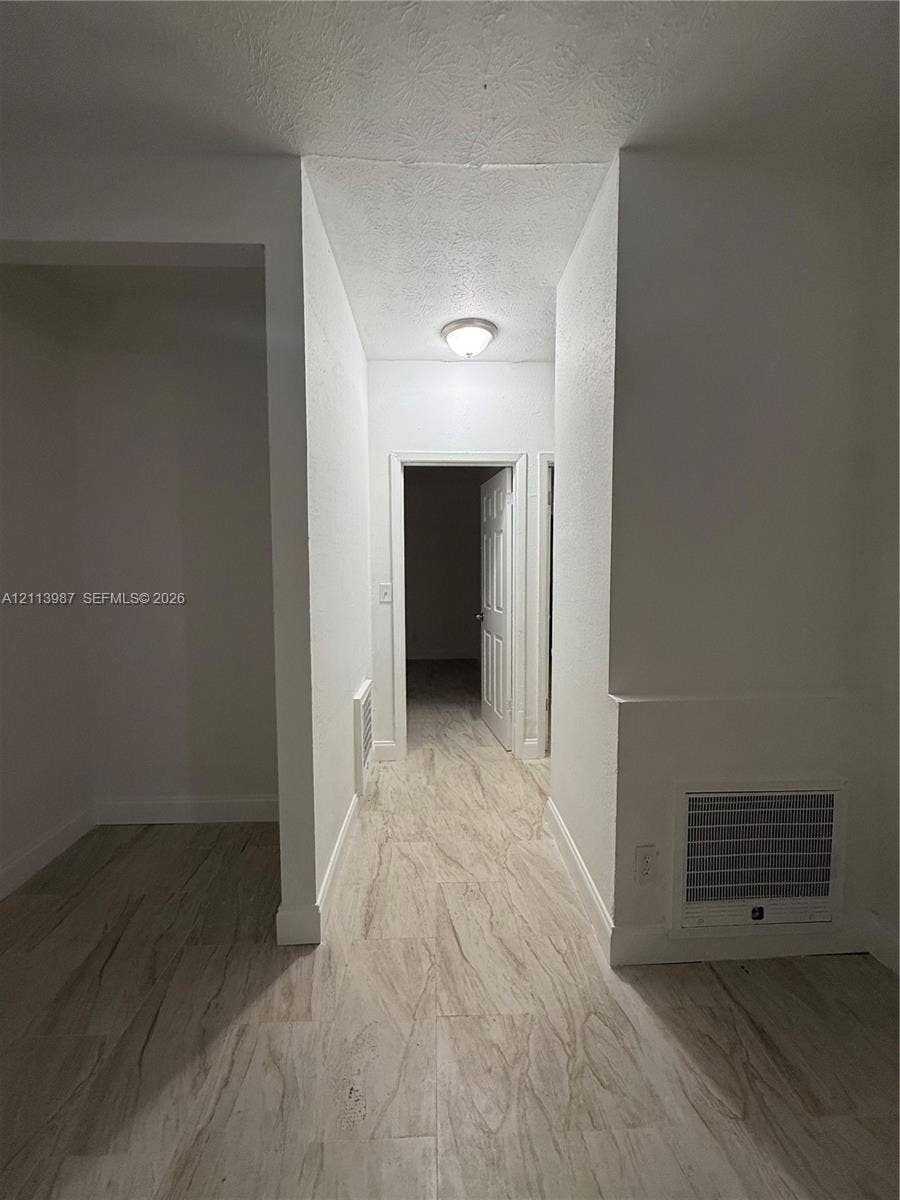 4428 Friden Drive, #4428, Jacksonville, Jacksonville, FL 32209 Hallway featuring wood-finish flooring, white walls, and a ceiling-mounted flush light fixture