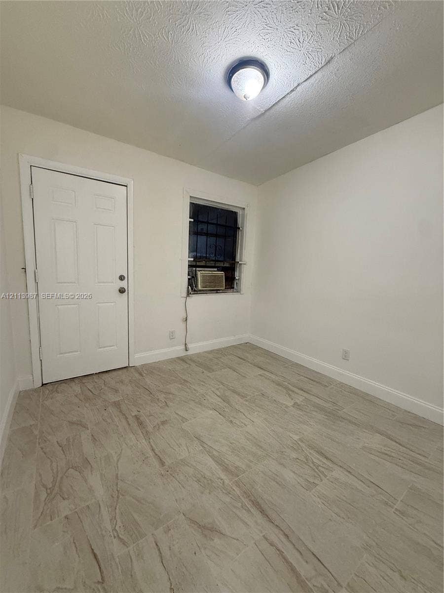 4428 Friden Drive, #4428, Jacksonville, Jacksonville, FL 32209 Neutral-toned tile flooring, solid-core interior door, and flush-mount ceiling light fixture