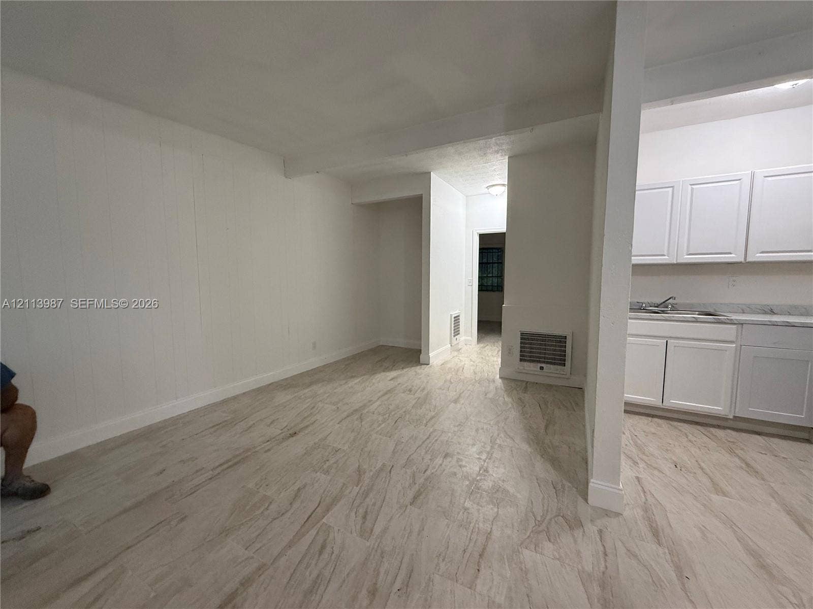 4428 Friden Drive, #4428, Jacksonville, Jacksonville, FL 32209 Interior space featuring neutral wall finishes, wood-finish tile flooring, white shaker-style cabinetry, and stone-finish countertops