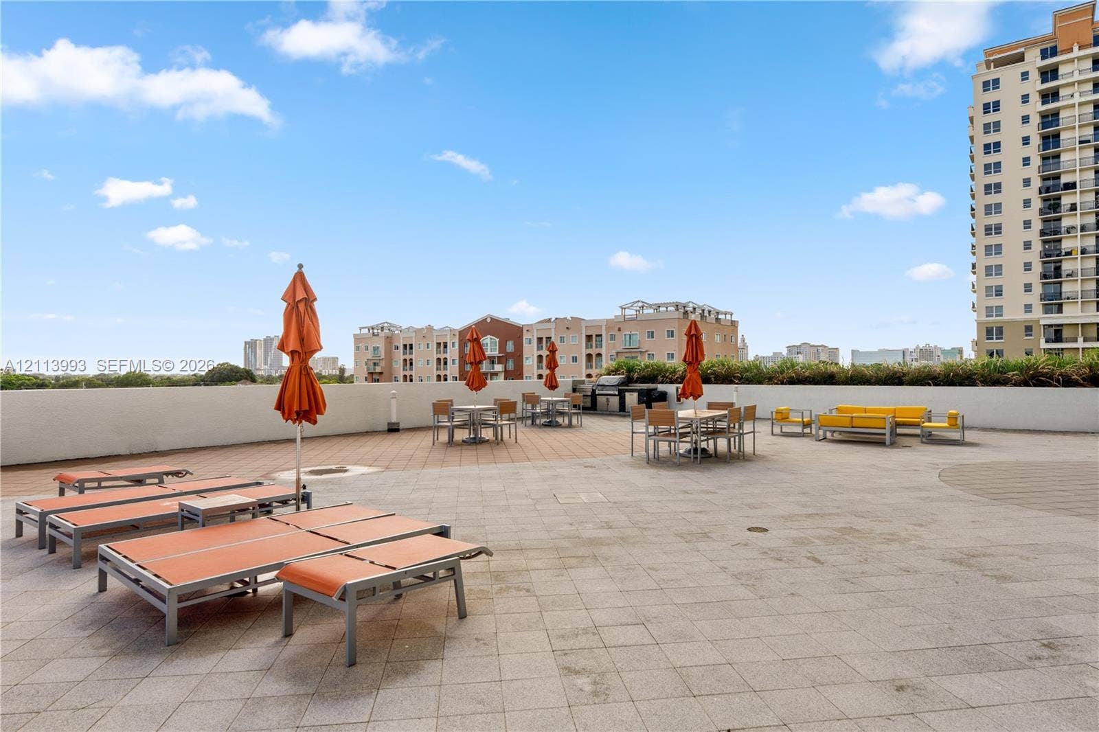 3180 SW 22nd Terrace, #407, Miami, Miami, FL 33145 Expansive rooftop terrace featuring paved stone flooring, perimeter masonry walls, and a built-in outdoor cooking station