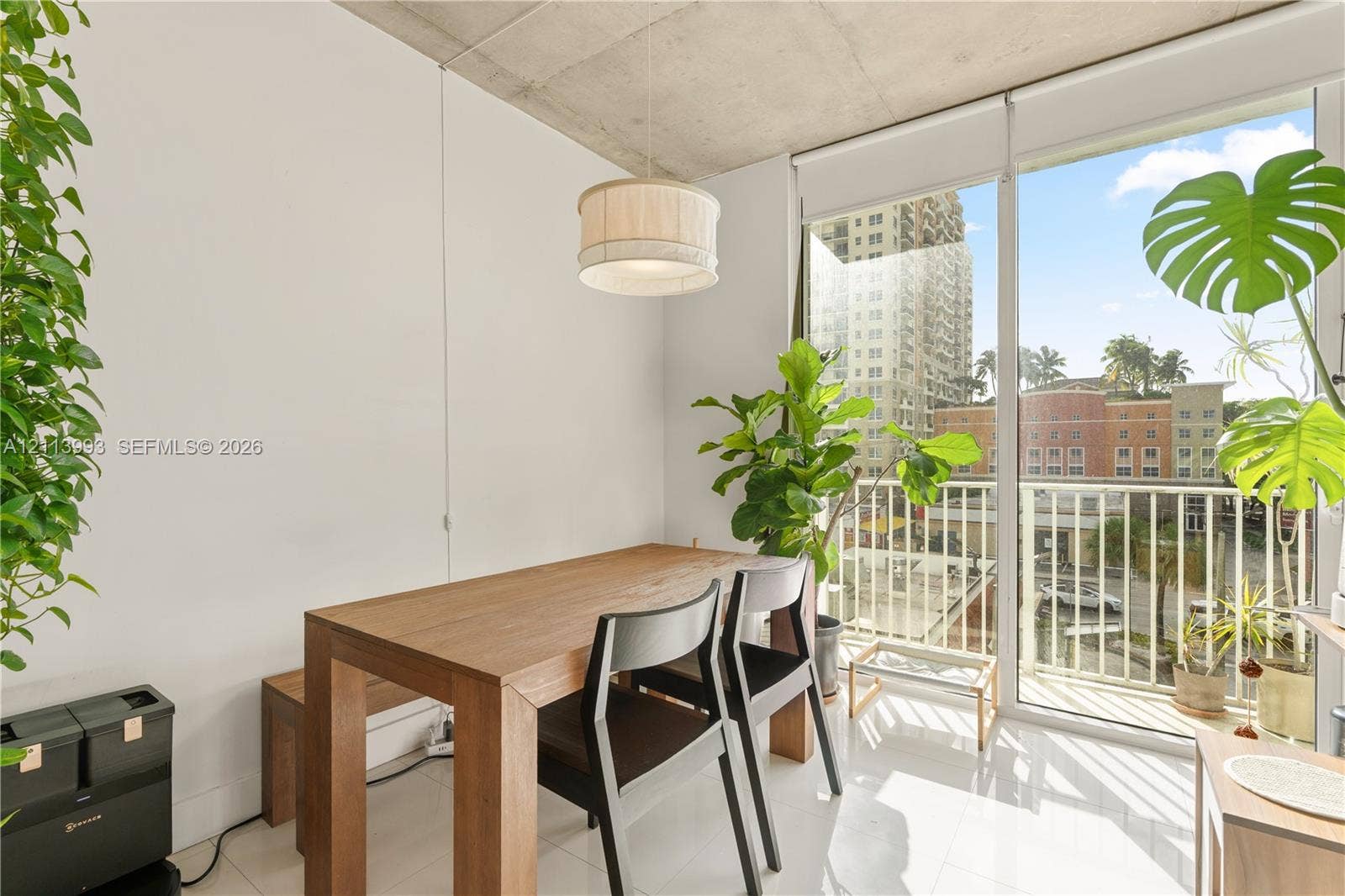 3180 SW 22nd Terrace, #407, Miami, Miami, FL 33145 Exposed concrete ceiling, floor-to-ceiling glass door, polished tile flooring, and a drum-style pendant light fixture