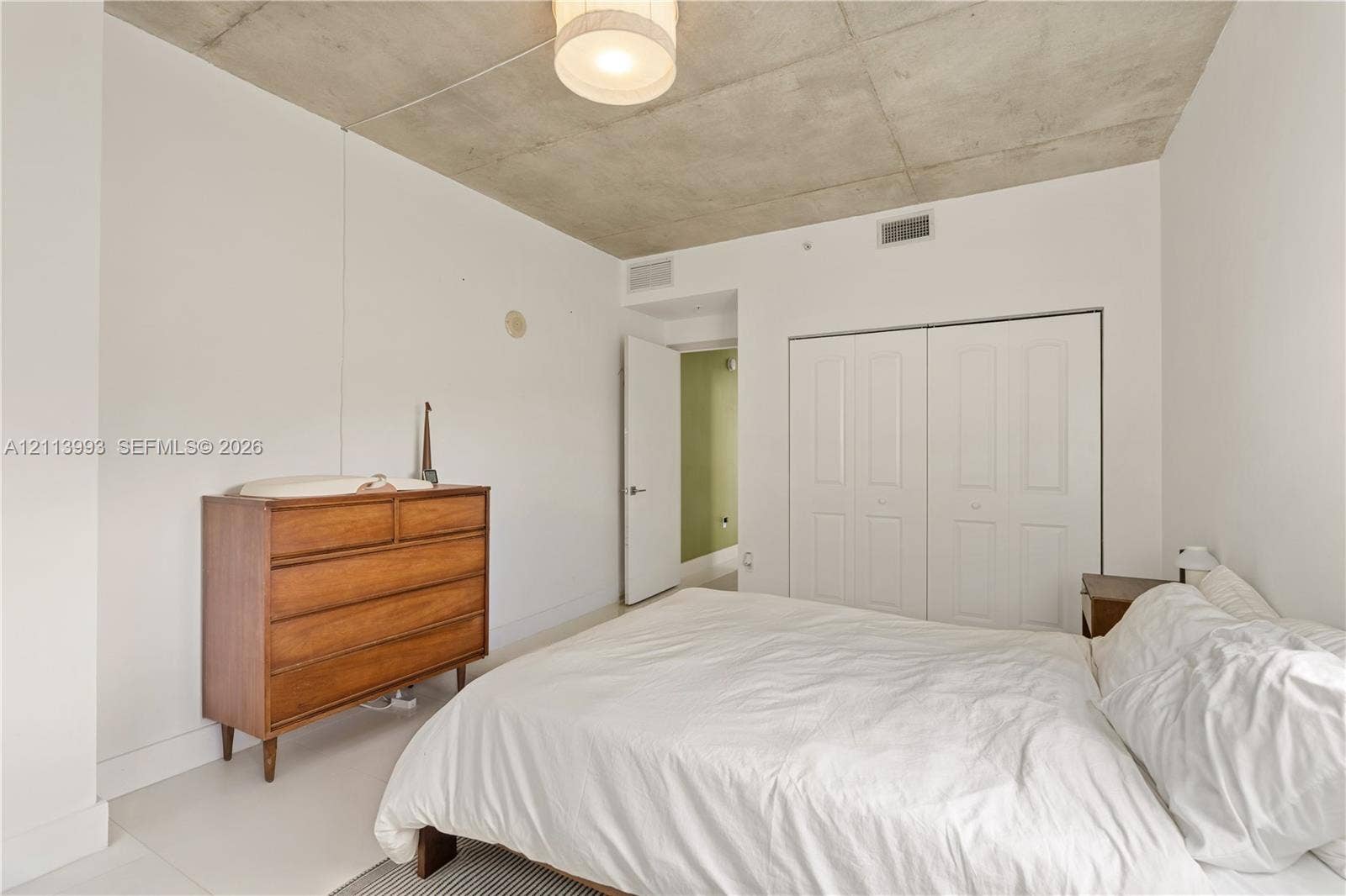 3180 SW 22nd Terrace, #407, Miami, Miami, FL 33145 Exposed concrete ceiling, white walls, and built-in double-door closet