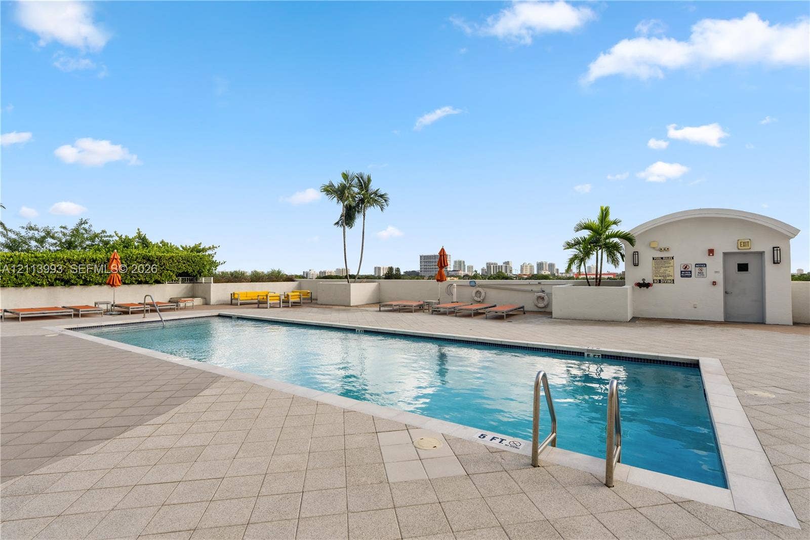 3180 SW 22nd Terrace, #407, Miami, Miami, FL 33145 Rooftop swimming pool featuring a tiled deck, perimeter landscaping, and stainless steel ladder entries