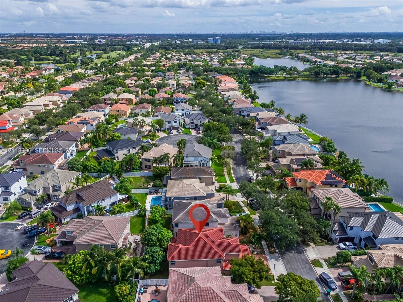 15503 SW 19th Street, Miramar, FL 33027 Aerial perspective featuring a multi-gabled residence with a terracotta tile roof and an attached swimming pool