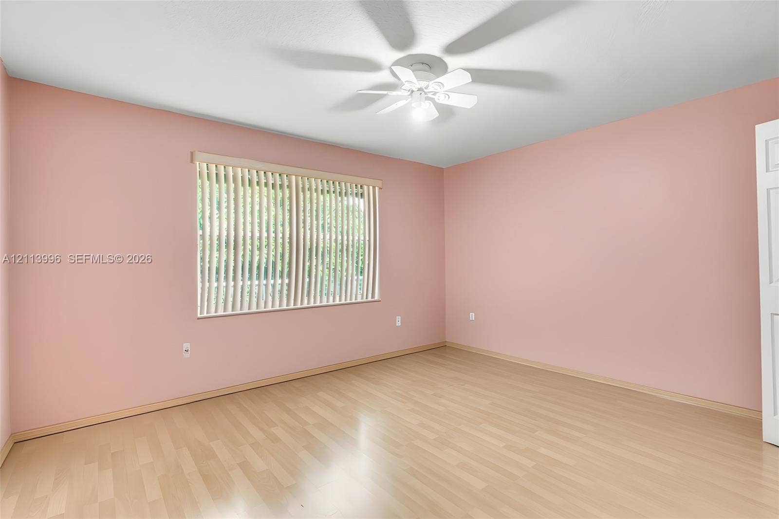 15503 SW 19th Street, Miramar, FL 33027 Interior room featuring light wood-finish flooring, a ceiling-mounted fan with integrated lighting, and vertical window blinds
