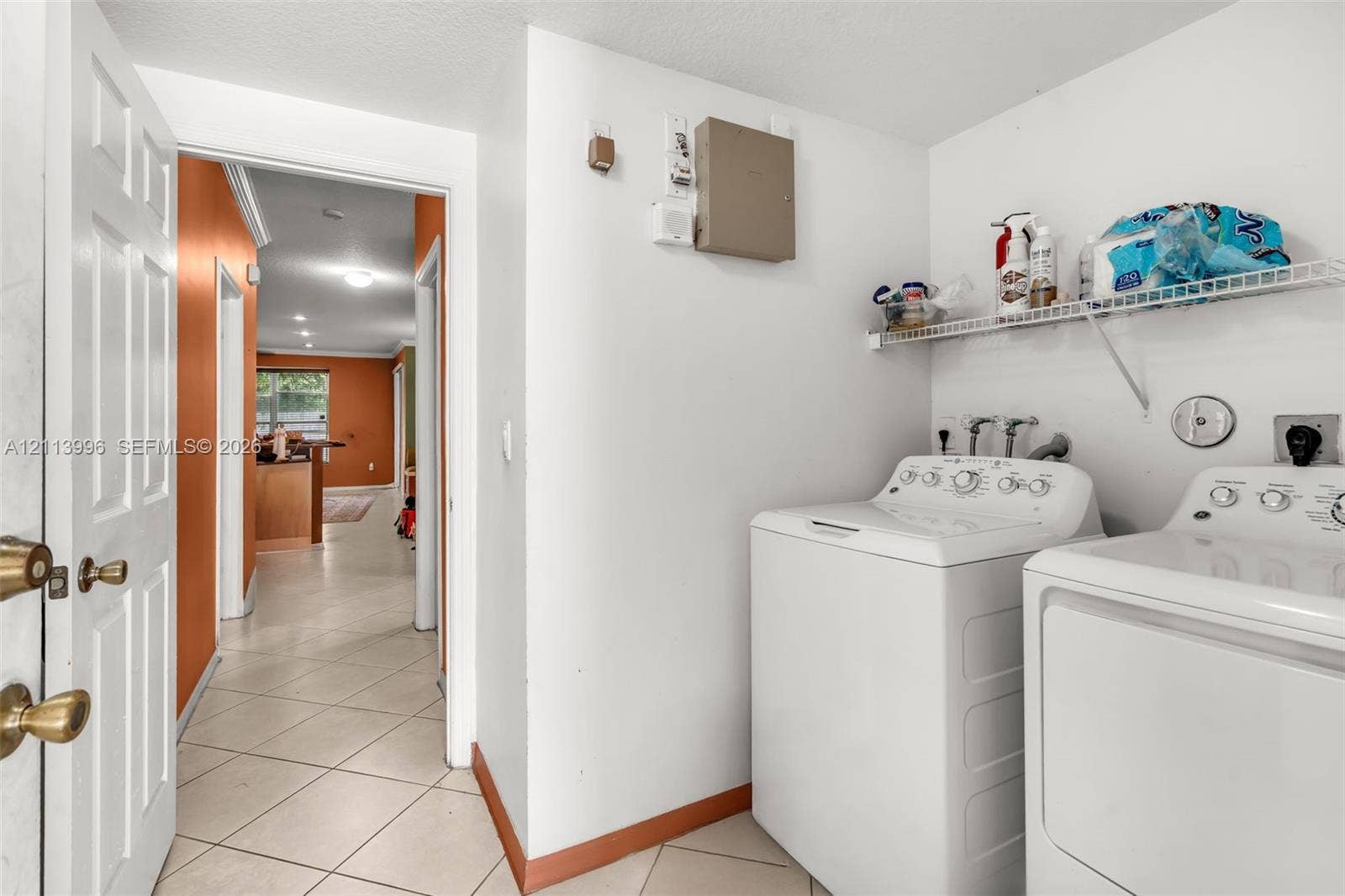 15503 SW 19th Street, Miramar, FL 33027 Laundry area featuring ceramic tile flooring, dedicated washer and dryer hookups, and a built-in wire shelving unit