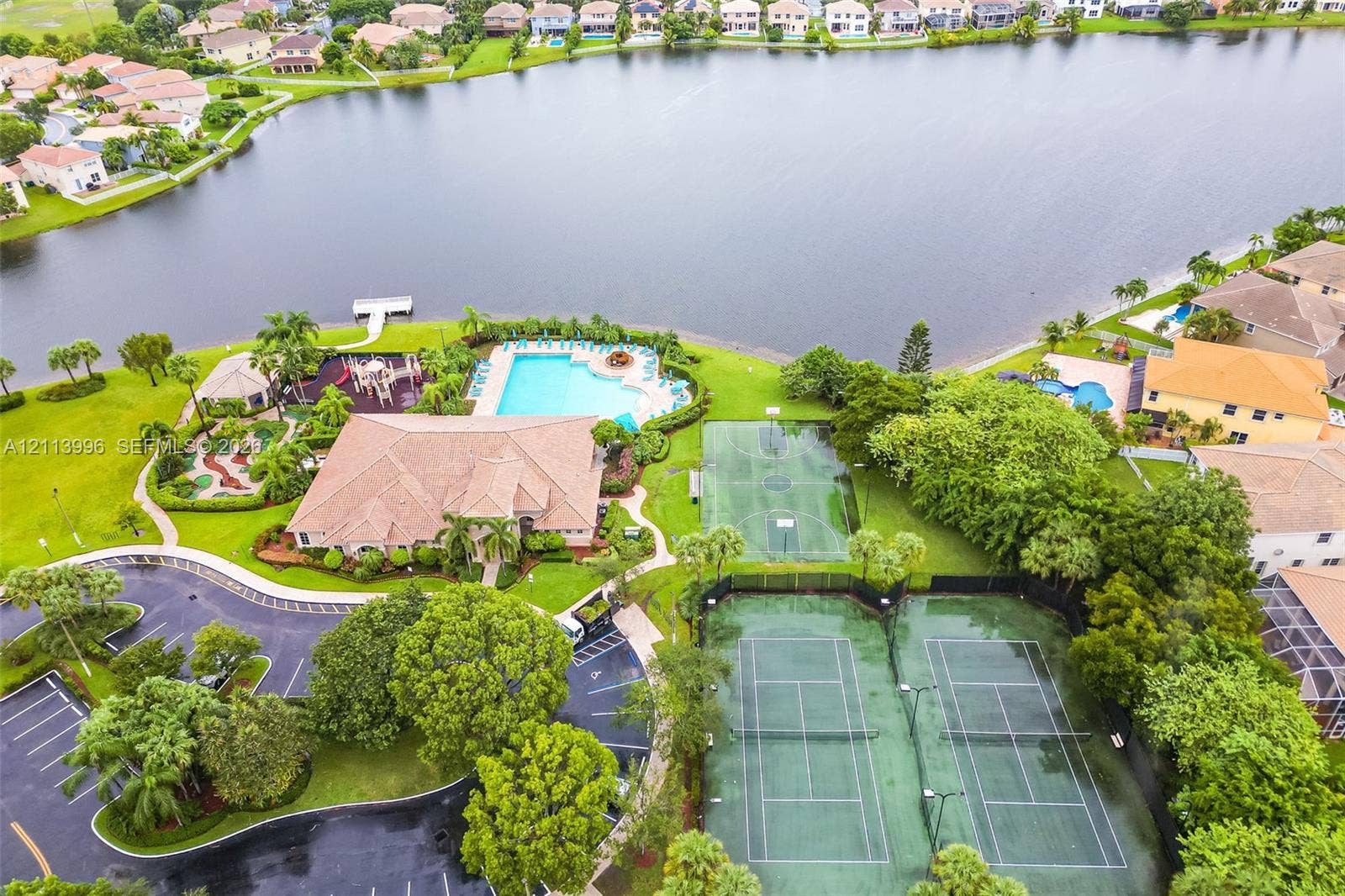 15503 SW 19th Street, Miramar, FL 33027 Waterfront recreational complex featuring an outdoor swimming pool, two tennis courts, a basketball court, and a miniature golf course