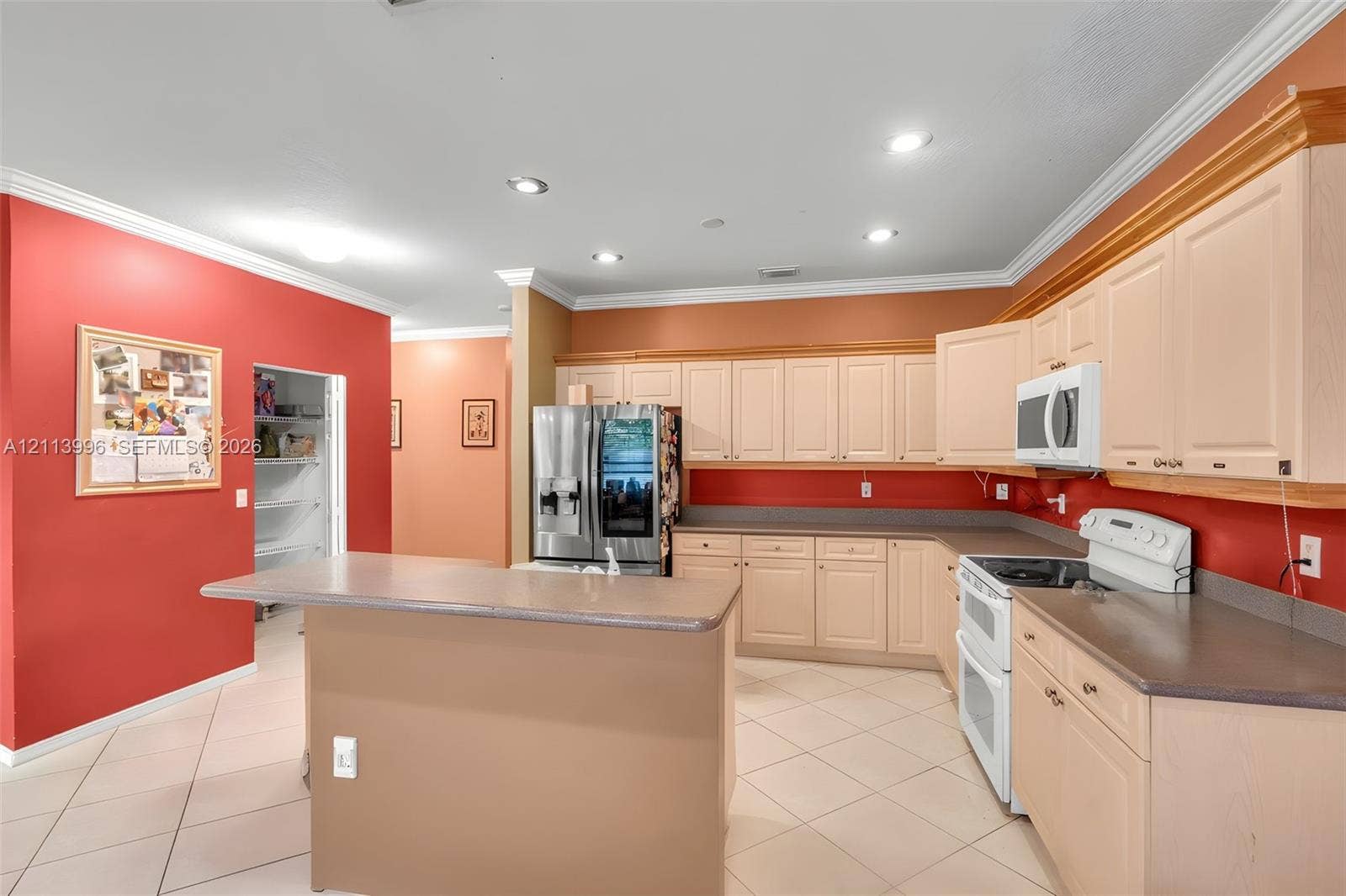 15503 SW 19th Street, Miramar, FL 33027 Kitchen featuring light-tone cabinetry, solid surface countertops, a walk-in pantry, recessed ceiling lighting, and ceramic tile flooring
