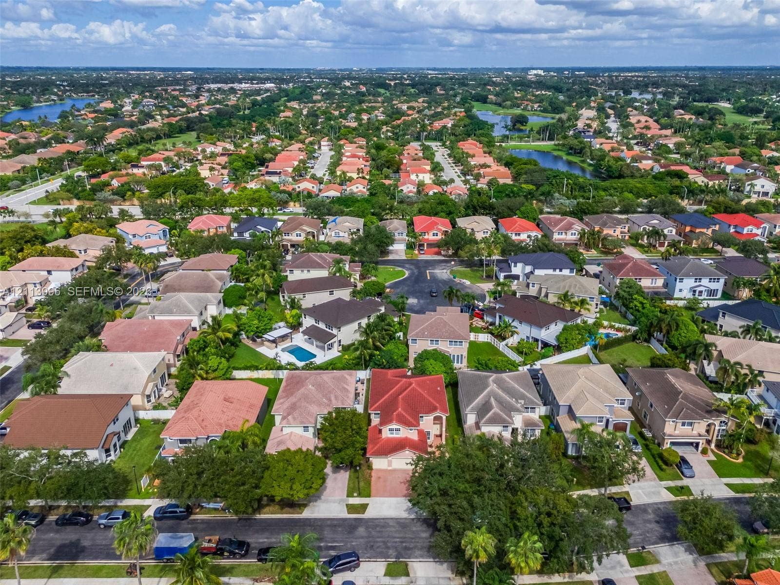 15503 SW 19th Street, Miramar, FL 33027 Aerial perspective of a multi-story residence featuring a red tile roof, concrete driveway, and attached garage within a landscaped residential neighborhood