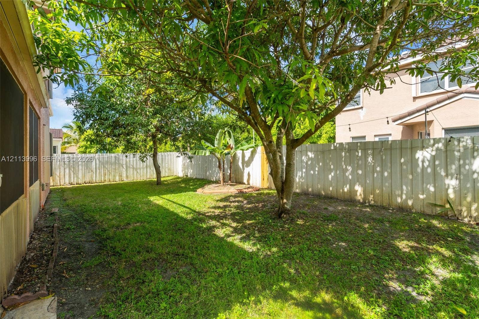15503 SW 19th Street, Miramar, FL 33027 Backyard featuring privacy fencing, mature trees, and ground-level plantings