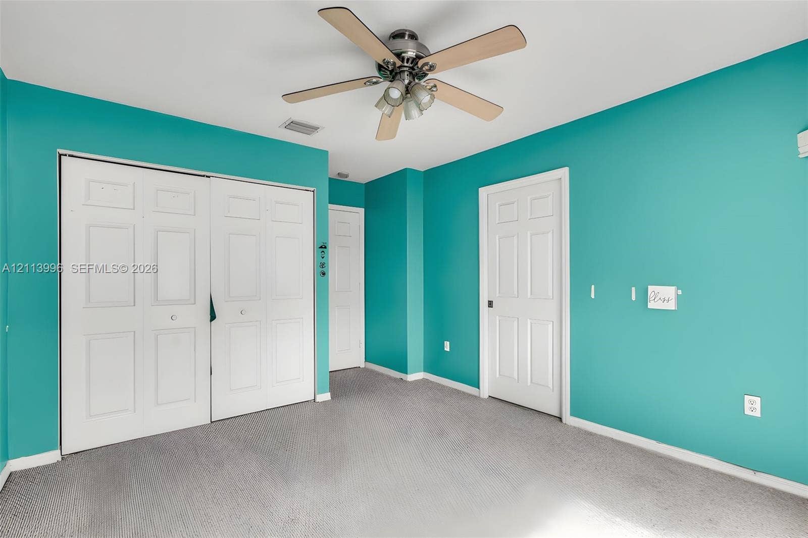 15503 SW 19th Street, Miramar, FL 33027 Room featuring gray carpeting, a multi-blade ceiling fan with integrated light fixture, and double-panel closet doors