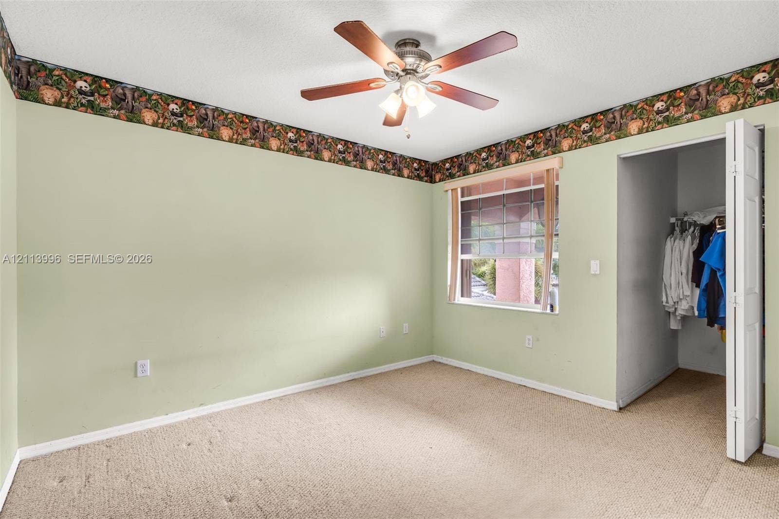15503 SW 19th Street, Miramar, FL 33027 Bedroom featuring neutral wall-to-wall carpeting, a ceiling fan with integrated lighting, and a bi-fold closet door