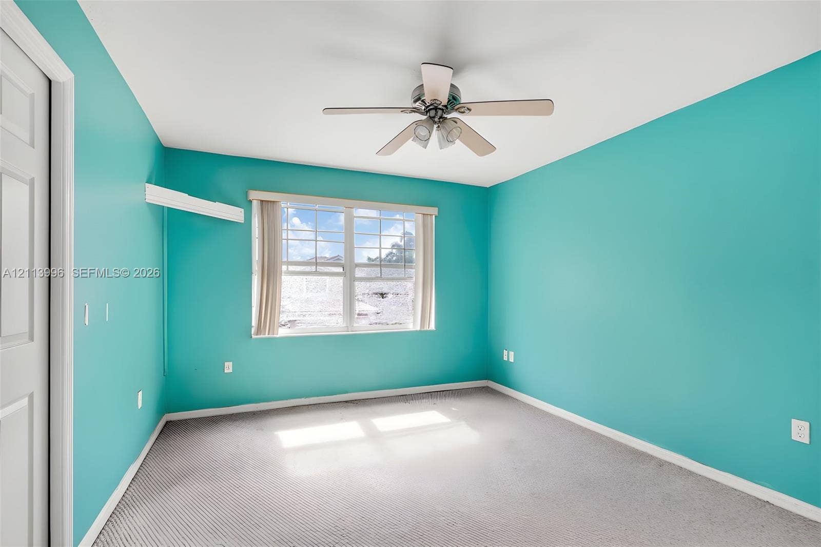 15503 SW 19th Street, Miramar, FL 33027 Room featuring carpeted flooring, a multi-blade ceiling fan with integrated lighting, and a multi-pane window