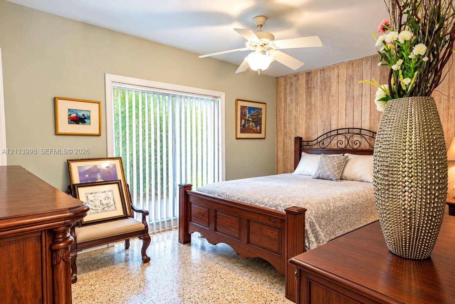 16455 SW 91st Avenue, Palmetto Bay, FL 33157 Bedroom featuring a wood-plank accent wall, polished terrazzo flooring, ceiling fan with integrated lighting, and a floor-to-ceiling sliding glass door