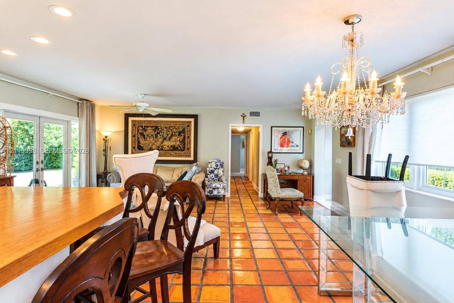 16455 SW 91st Avenue, Palmetto Bay, FL 33157 Terracotta tile flooring, decorative crystal chandelier, recessed lighting, and glass paneled French doors