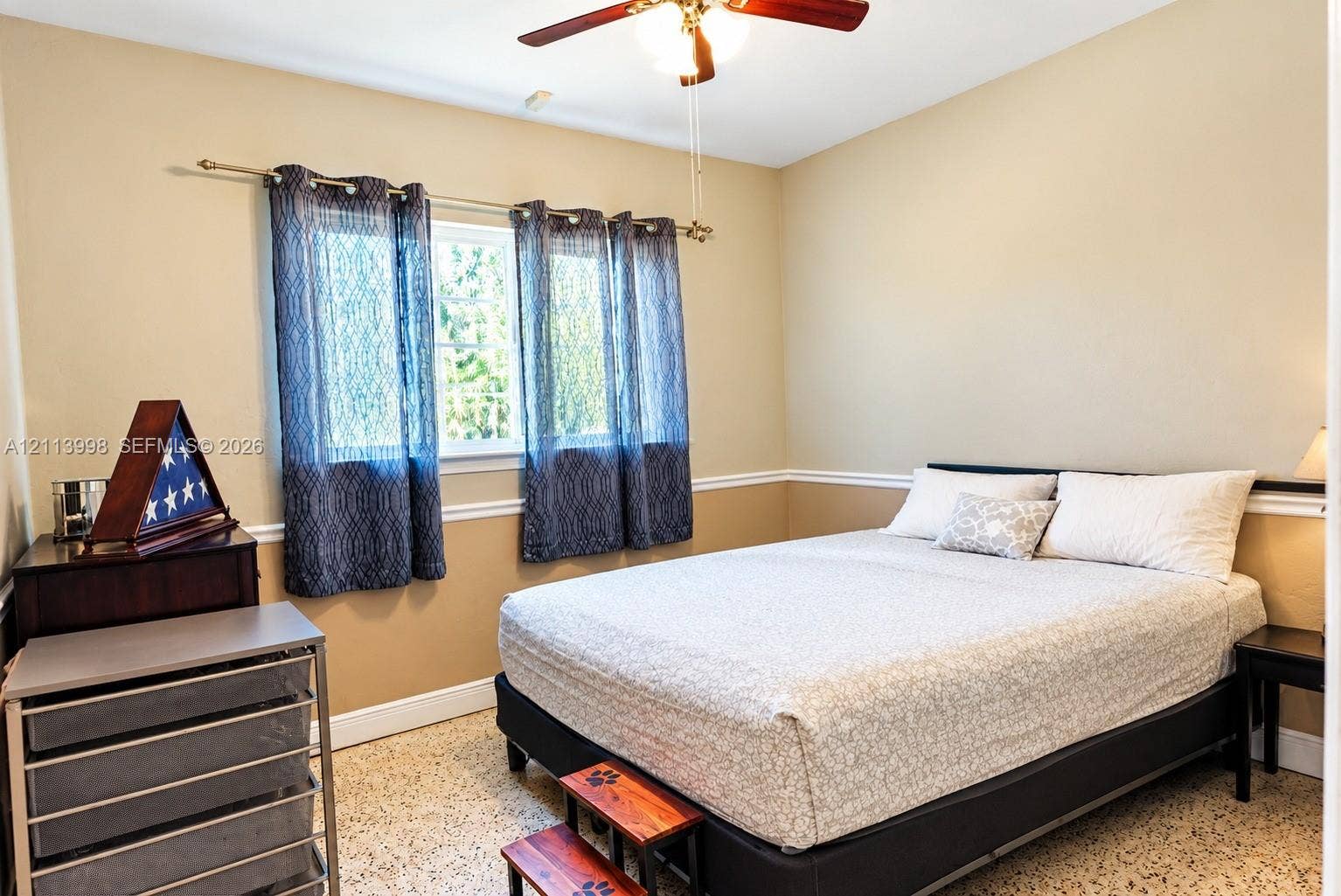 16455 SW 91st Avenue, Palmetto Bay, FL 33157 Room featuring neutral wall paint, white chair rail molding, ceiling fan with integrated lighting, and multi-pane window