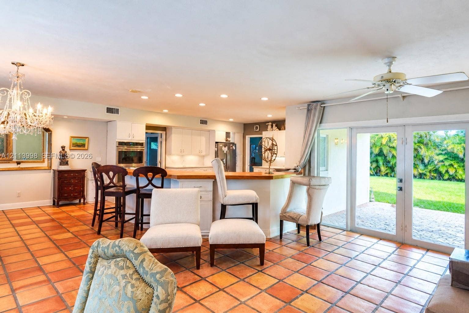 16455 SW 91st Avenue, Palmetto Bay, FL 33157 Kitchen featuring white cabinetry, wood-surface peninsula, built-in double oven, recessed lighting, and tile flooring
