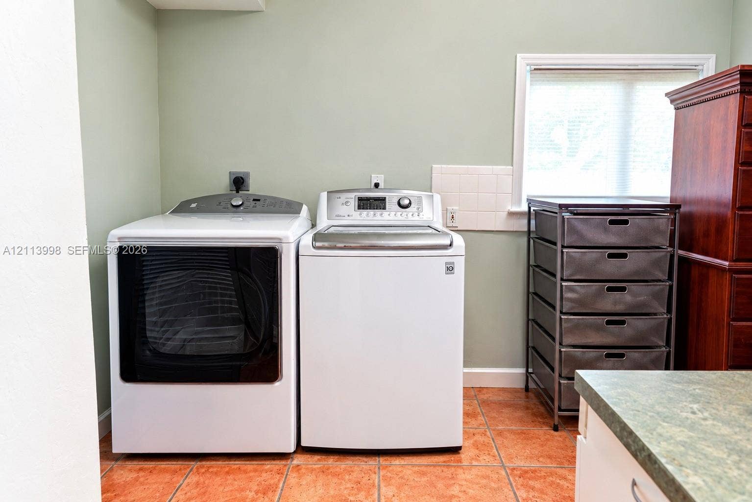 16455 SW 91st Avenue, Palmetto Bay, FL 33157 Dedicated laundry area featuring ceramic tile flooring, neutral wall tones, and a window with blinds