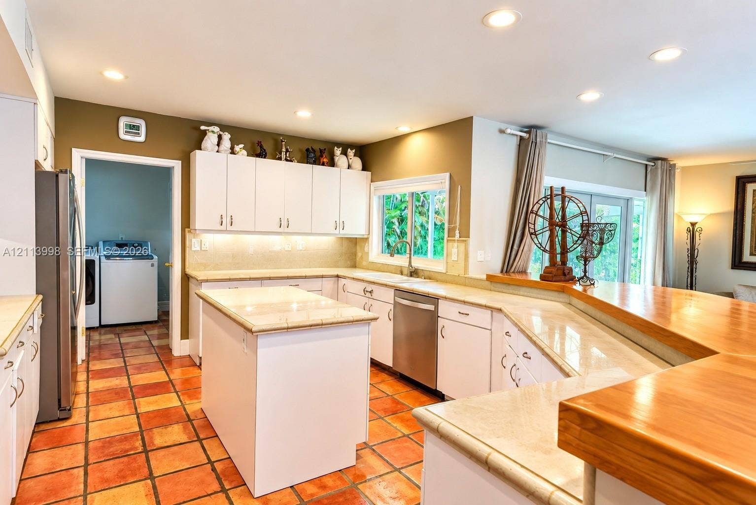 16455 SW 91st Avenue, Palmetto Bay, FL 33157 Kitchen featuring white cabinetry, center island, tile-topped counters, recessed lighting, and tile flooring