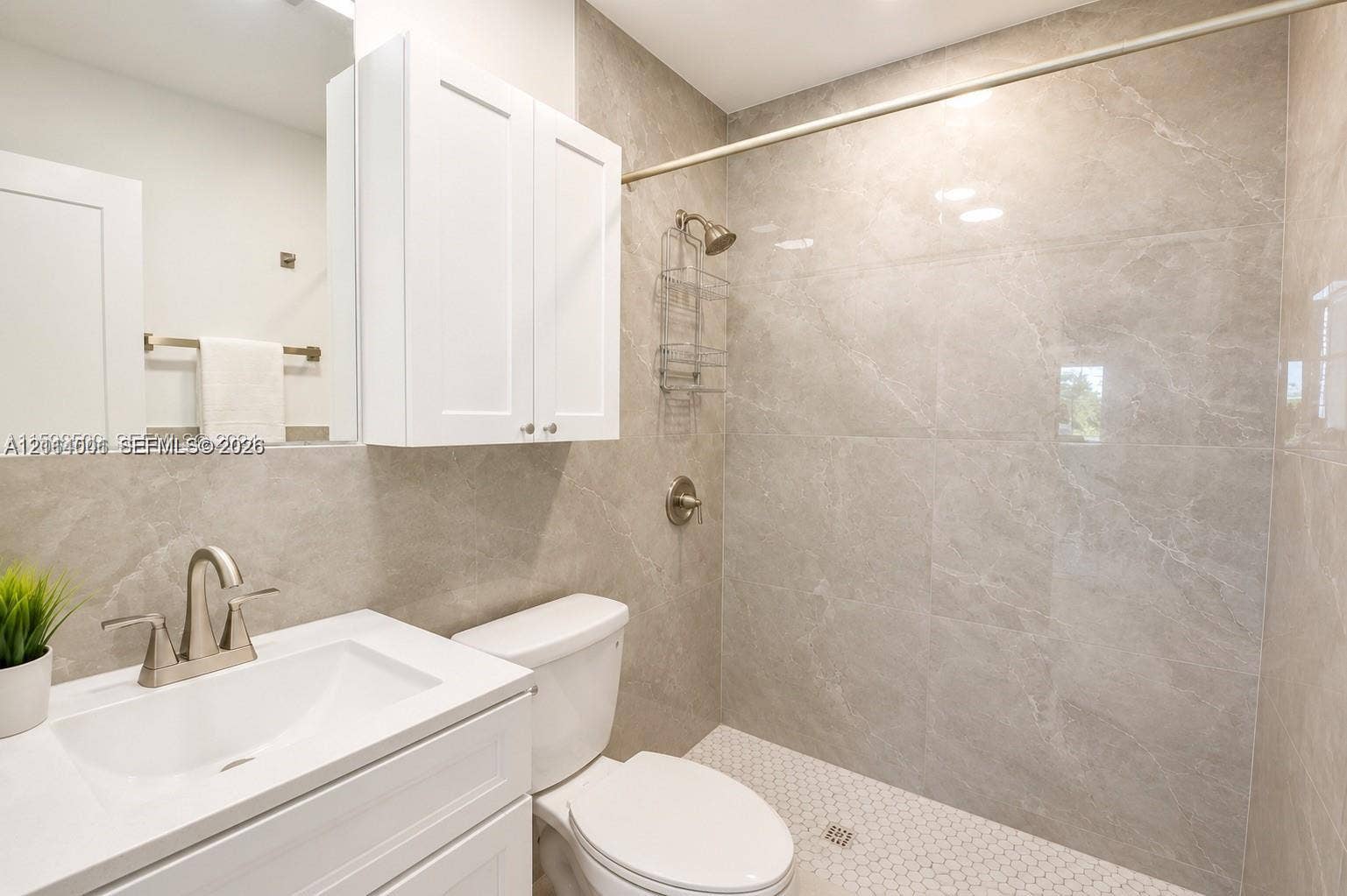 2611 SW 13th Avenue, #1-2, Fort Lauderdale, Fort Lauderdale, FL 33315 Bathroom featuring large-format gray tiled shower walls, white vanity cabinet with a integrated sink, polished chrome faucet, and geometric tile shower flooring