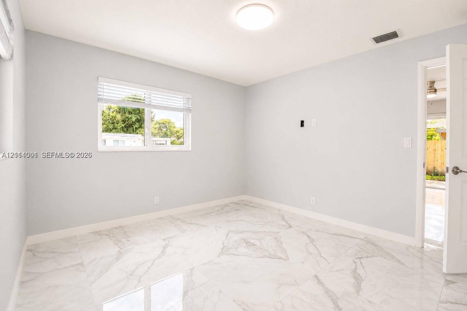 2611 SW 13th Avenue, #1-2, Fort Lauderdale, Fort Lauderdale, FL 33315 Neutral-toned room featuring large-format tile flooring with marble-style veining, recessed ceiling lighting, and a window with horizontal blinds