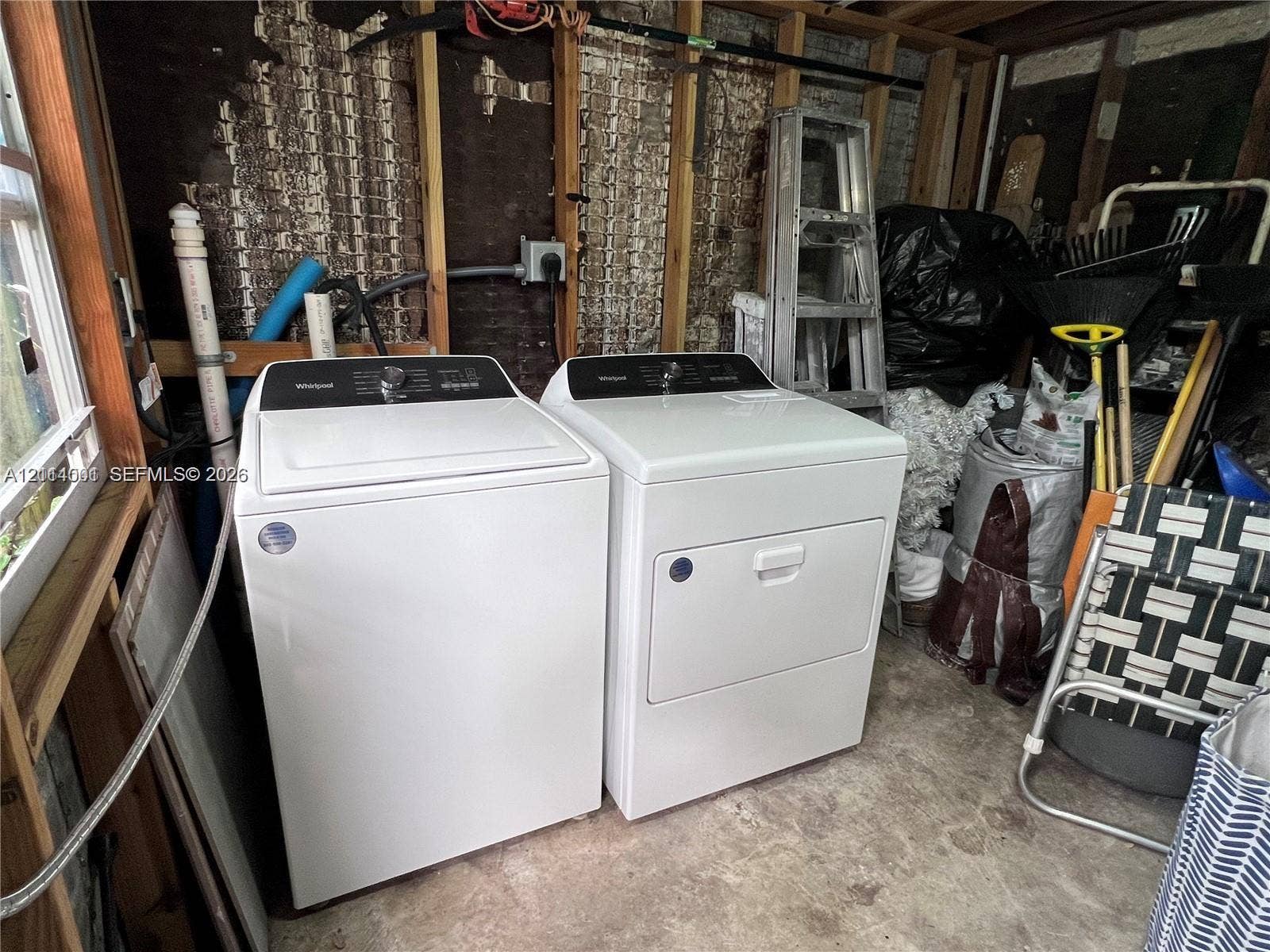 2611 SW 13th Avenue, #1-2, Fort Lauderdale, Fort Lauderdale, FL 33315 Top-loading washing machine and matching dryer pair situated on a concrete floor